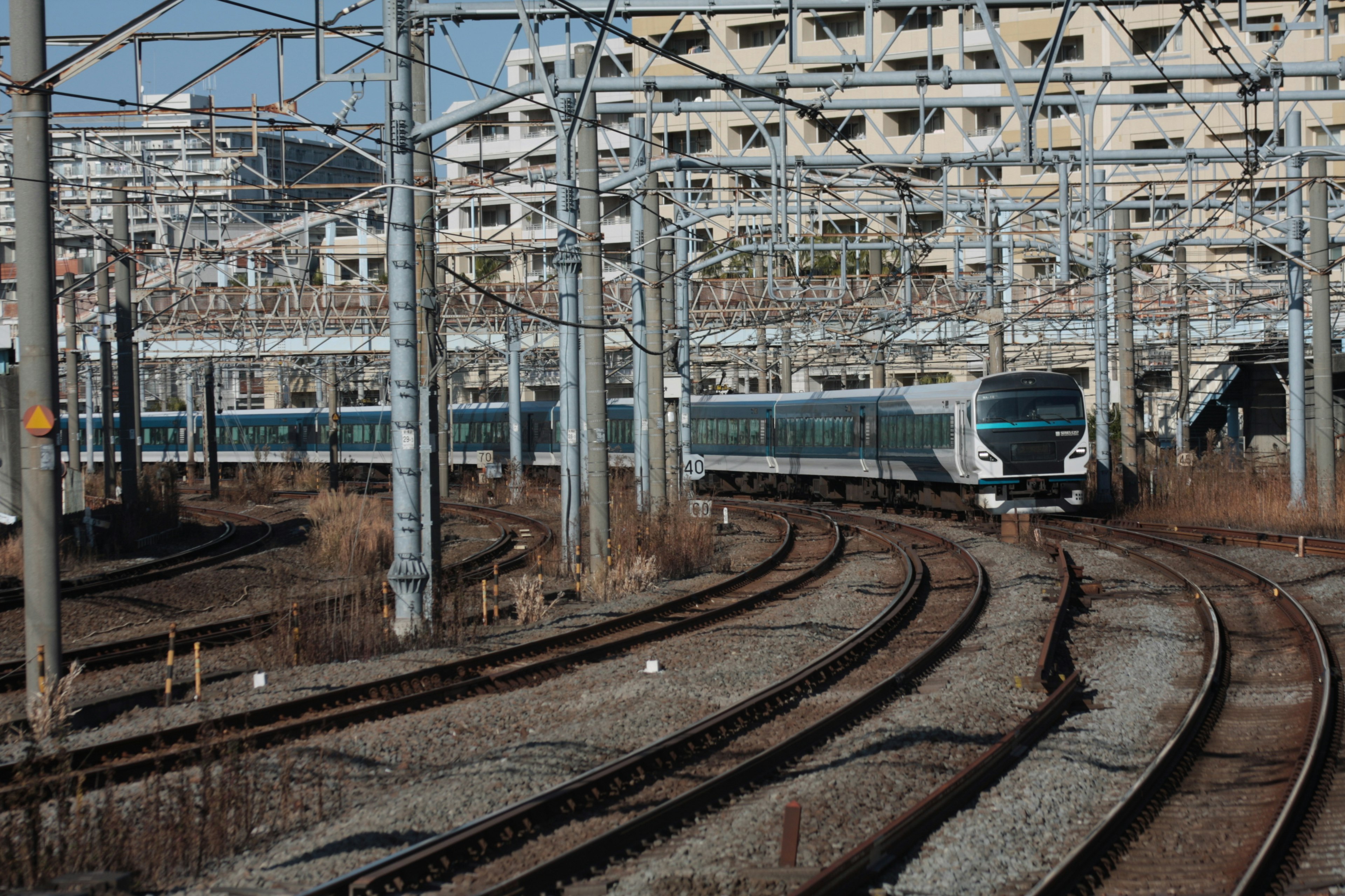 Curving railway tracks with overhead structures