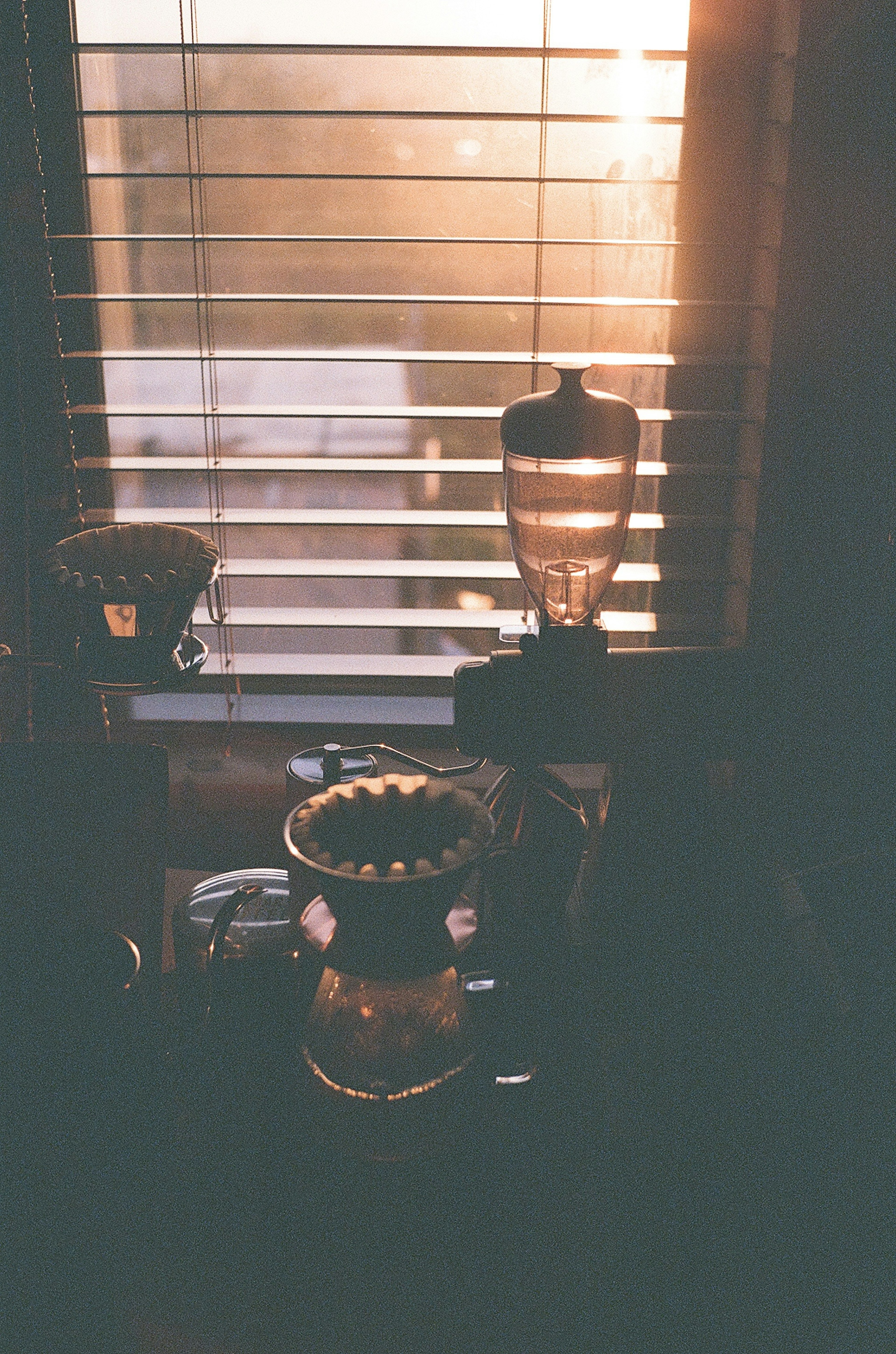 Decorative lamps and objects by the window illuminated by sunset