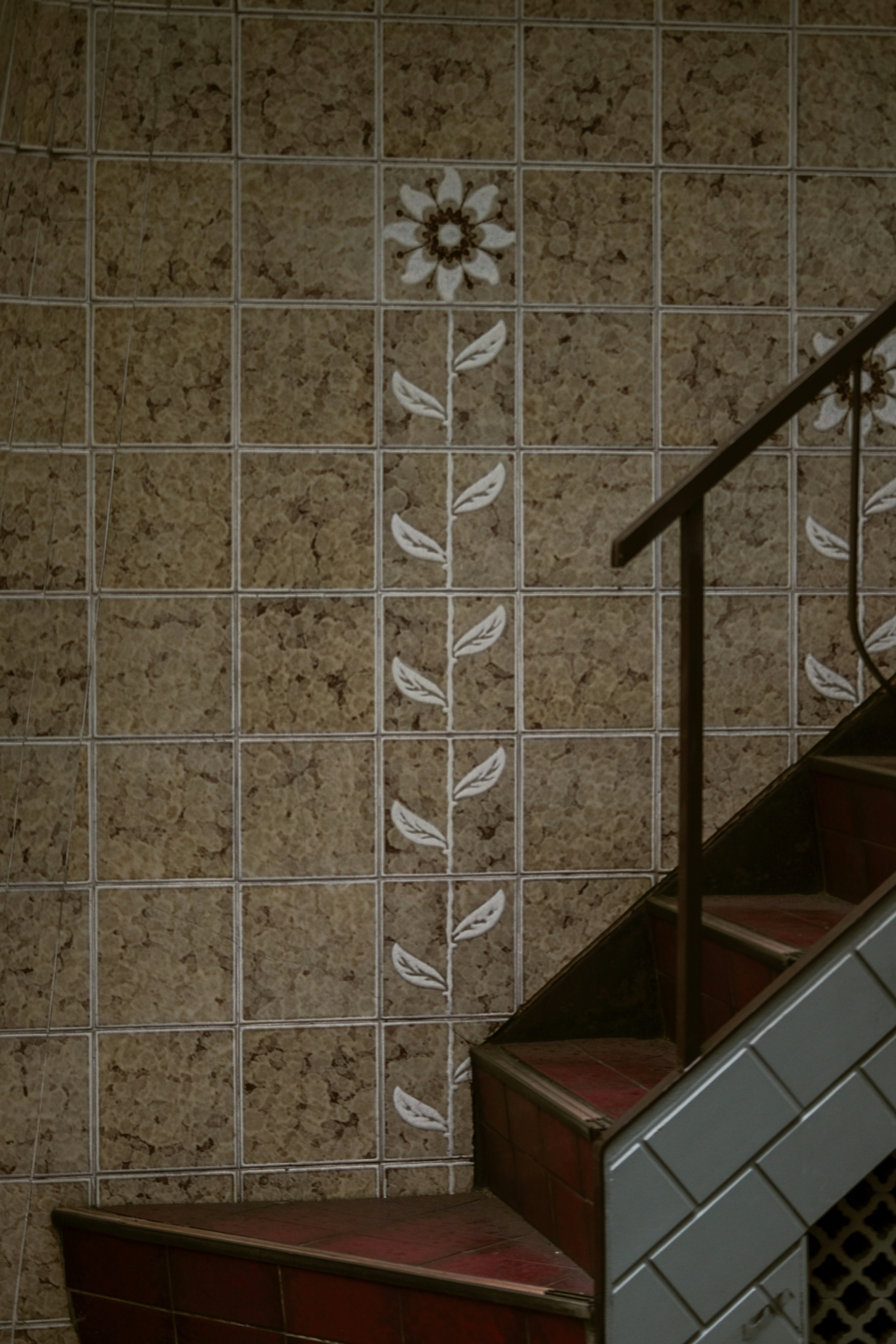 Carreaux décoratifs avec motif floral sur le mur de l'escalier