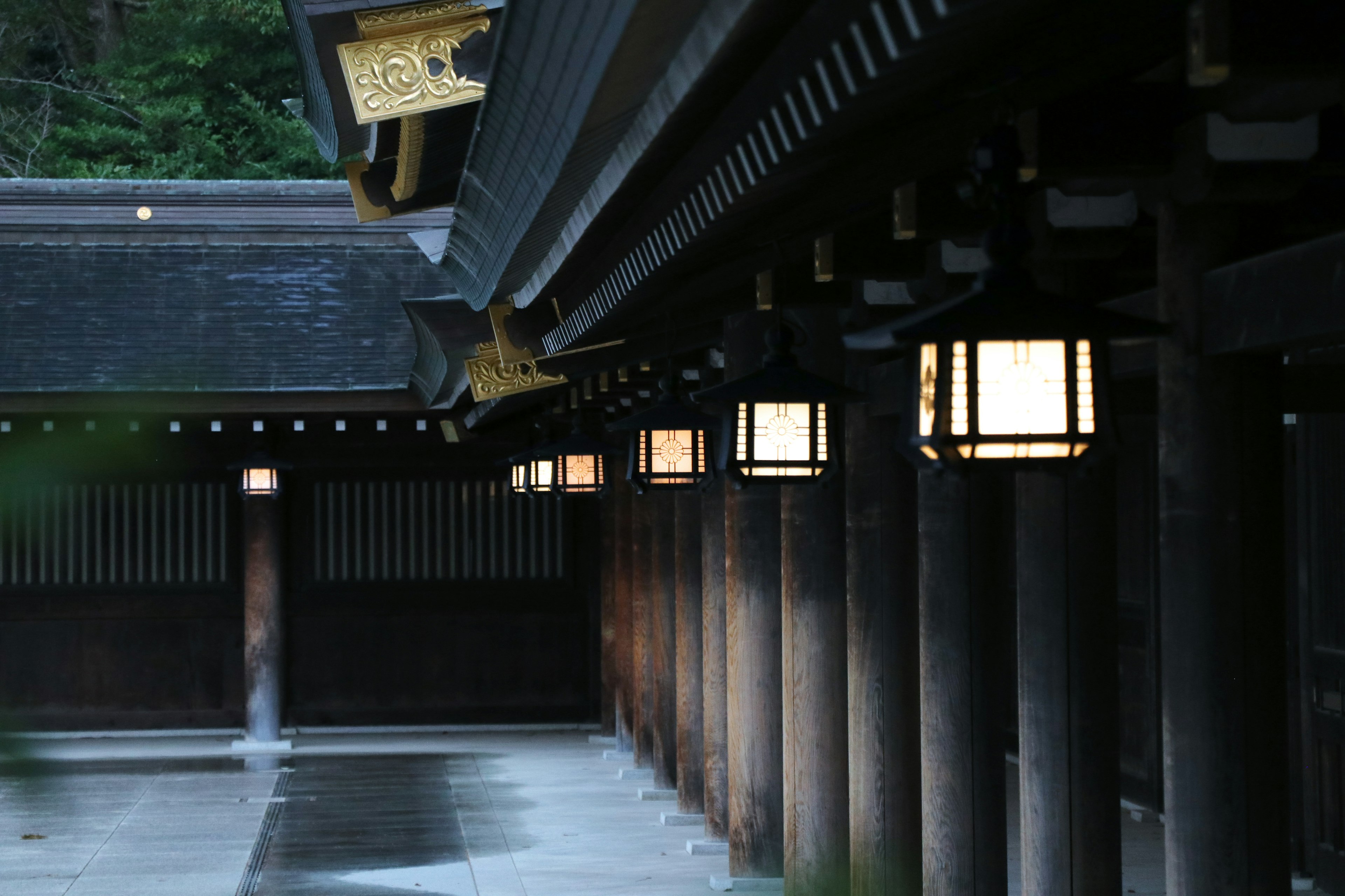 Serene view of lanterns and pillars along a temple corridor