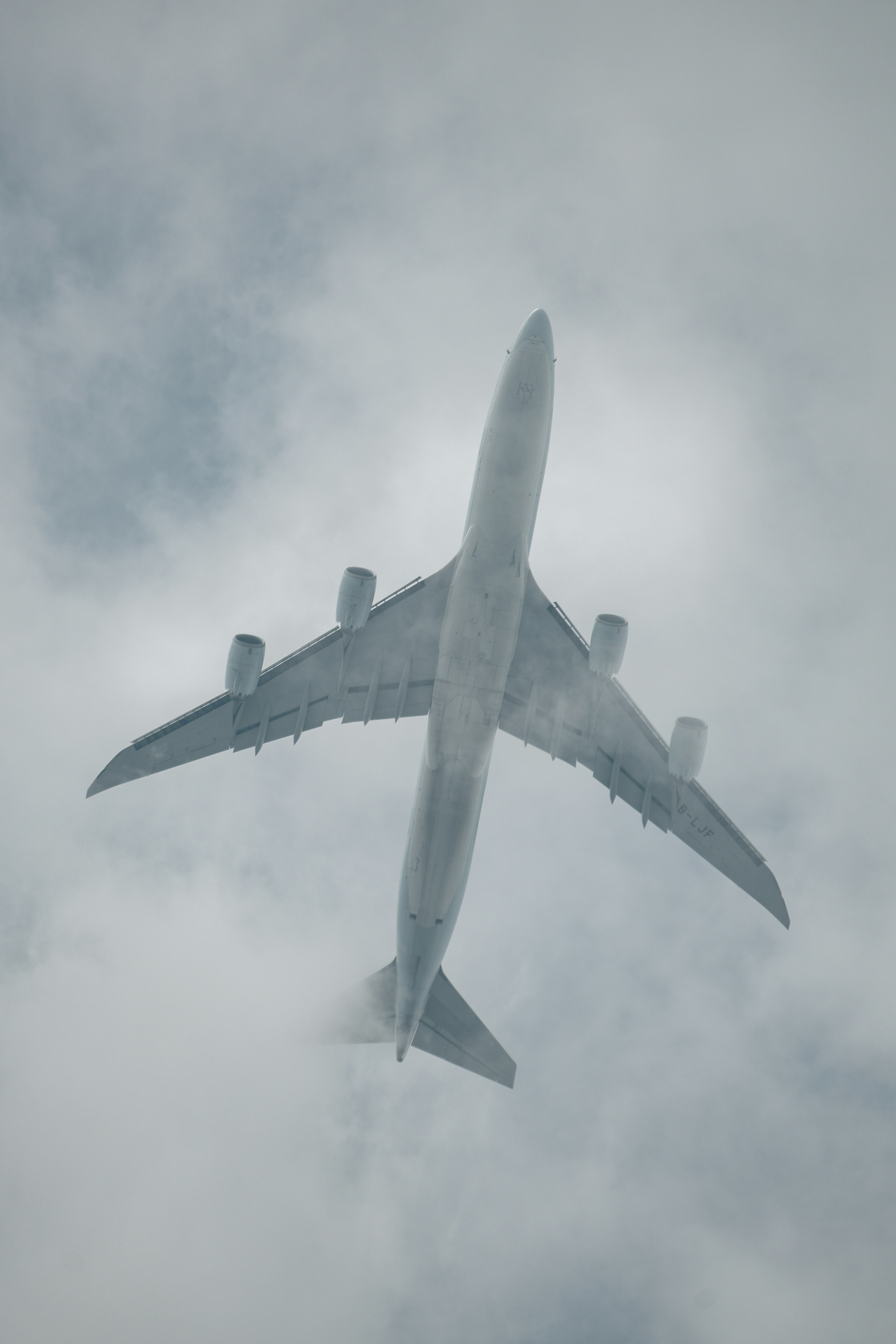 Large aircraft flying above the clouds