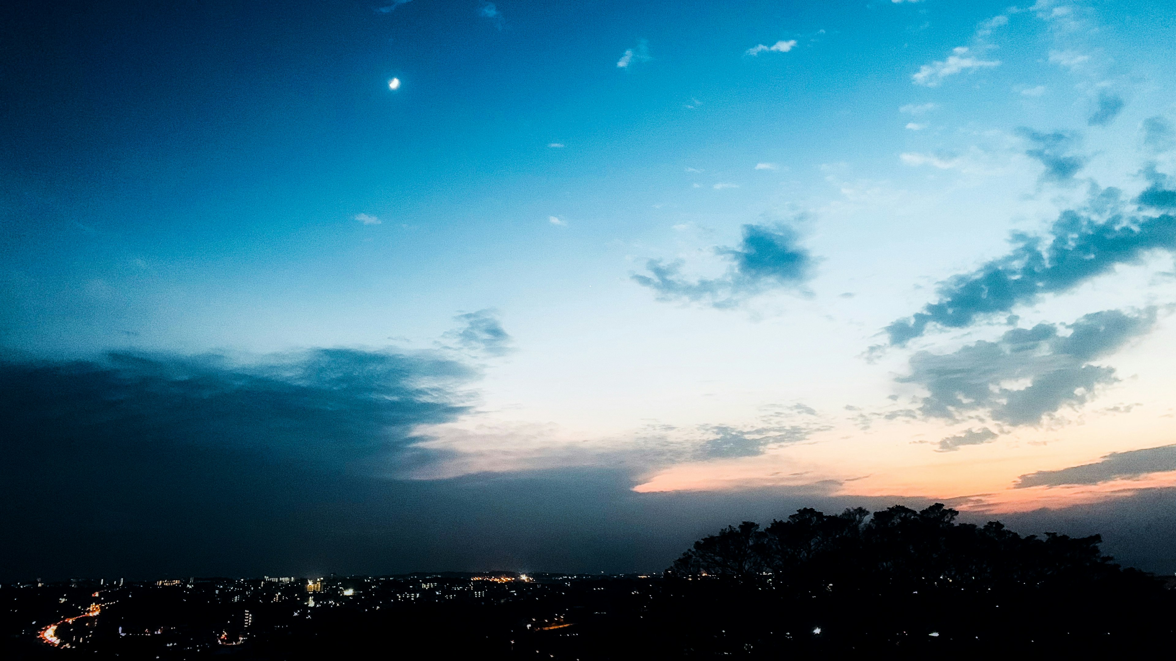 Twilight sky with city lights in the foreground