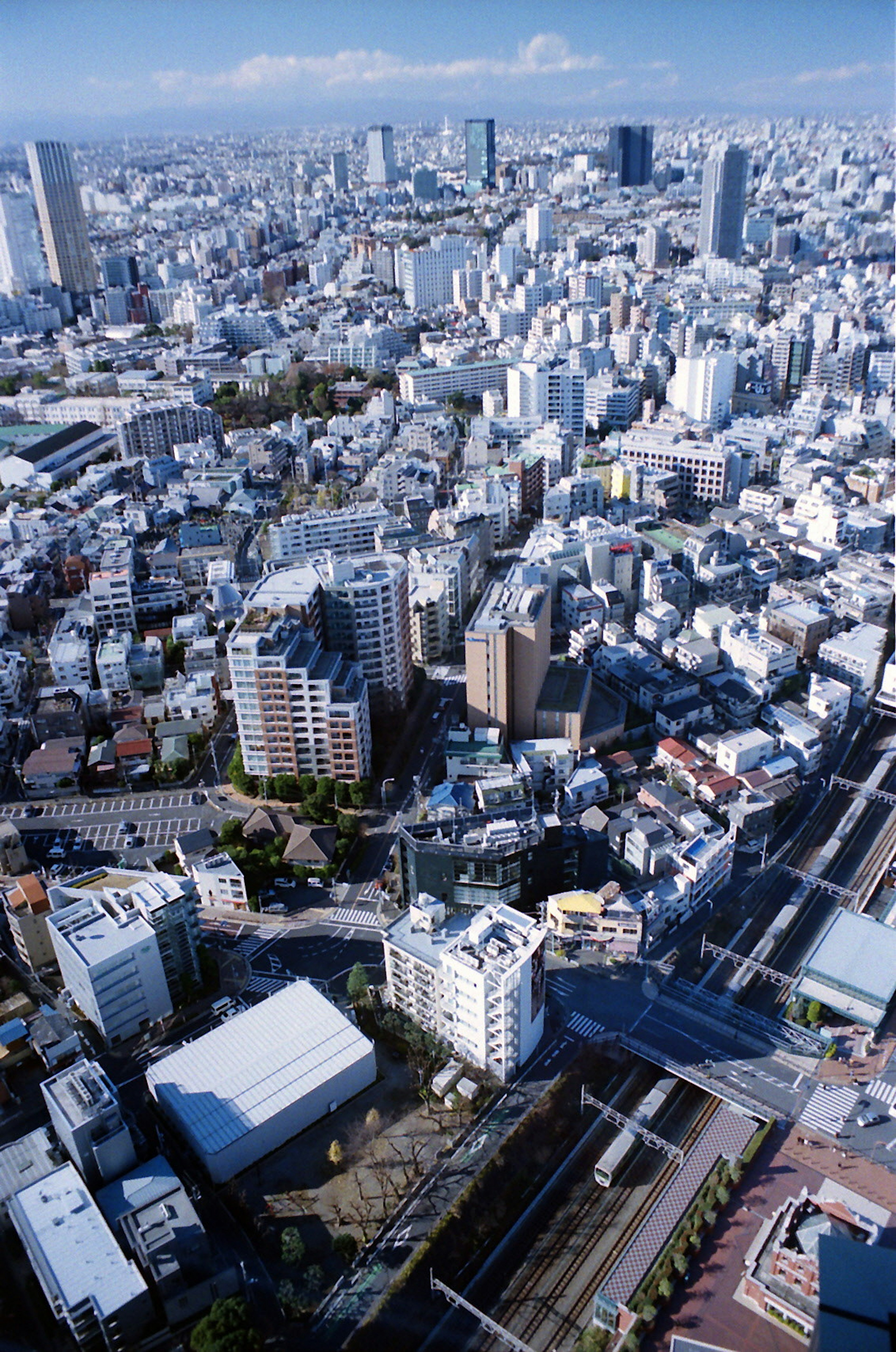 Aerial view of a densely populated urban area with high-rise buildings and residential structures