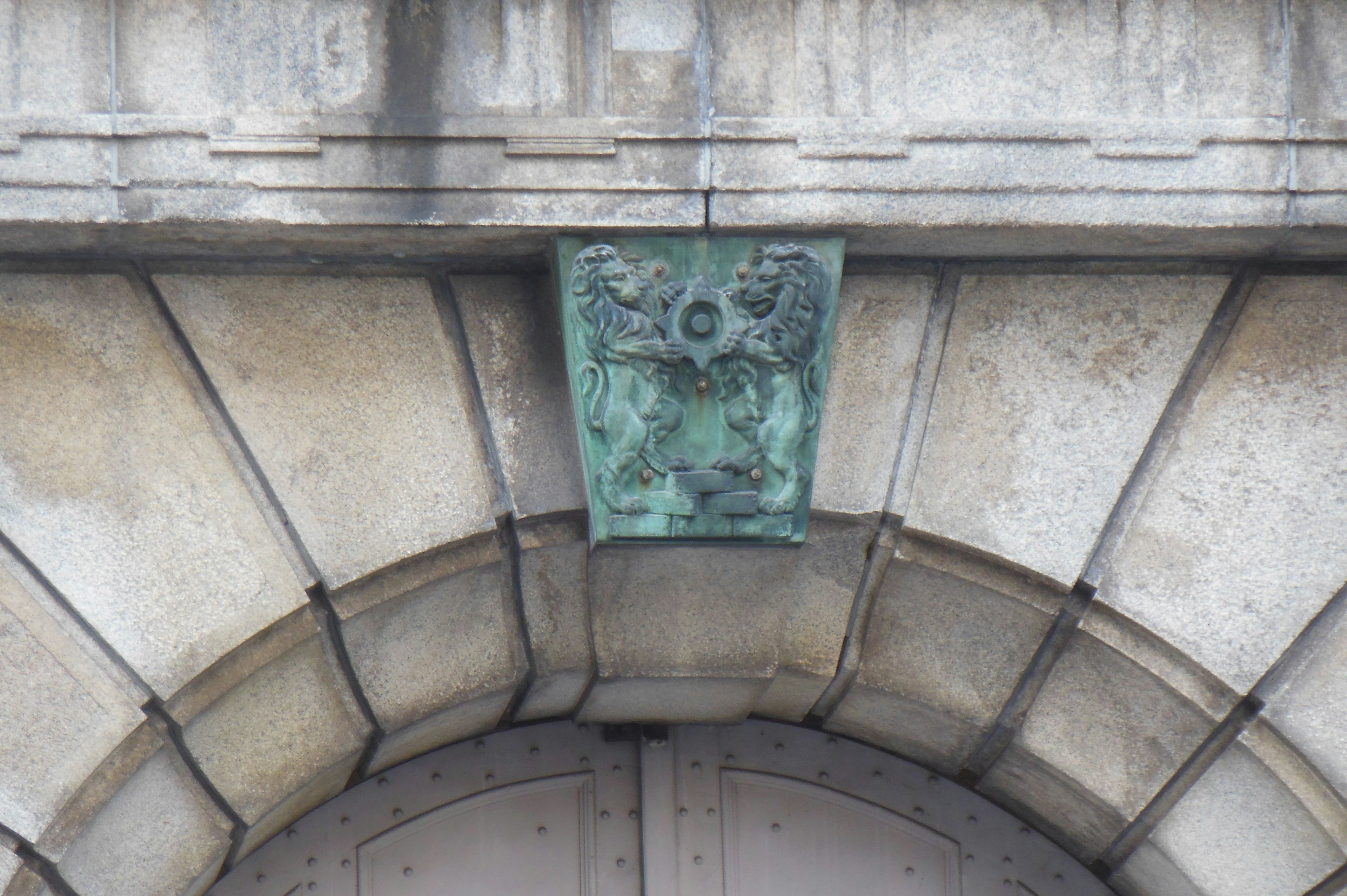 Bronze sculpture decoration above an arch