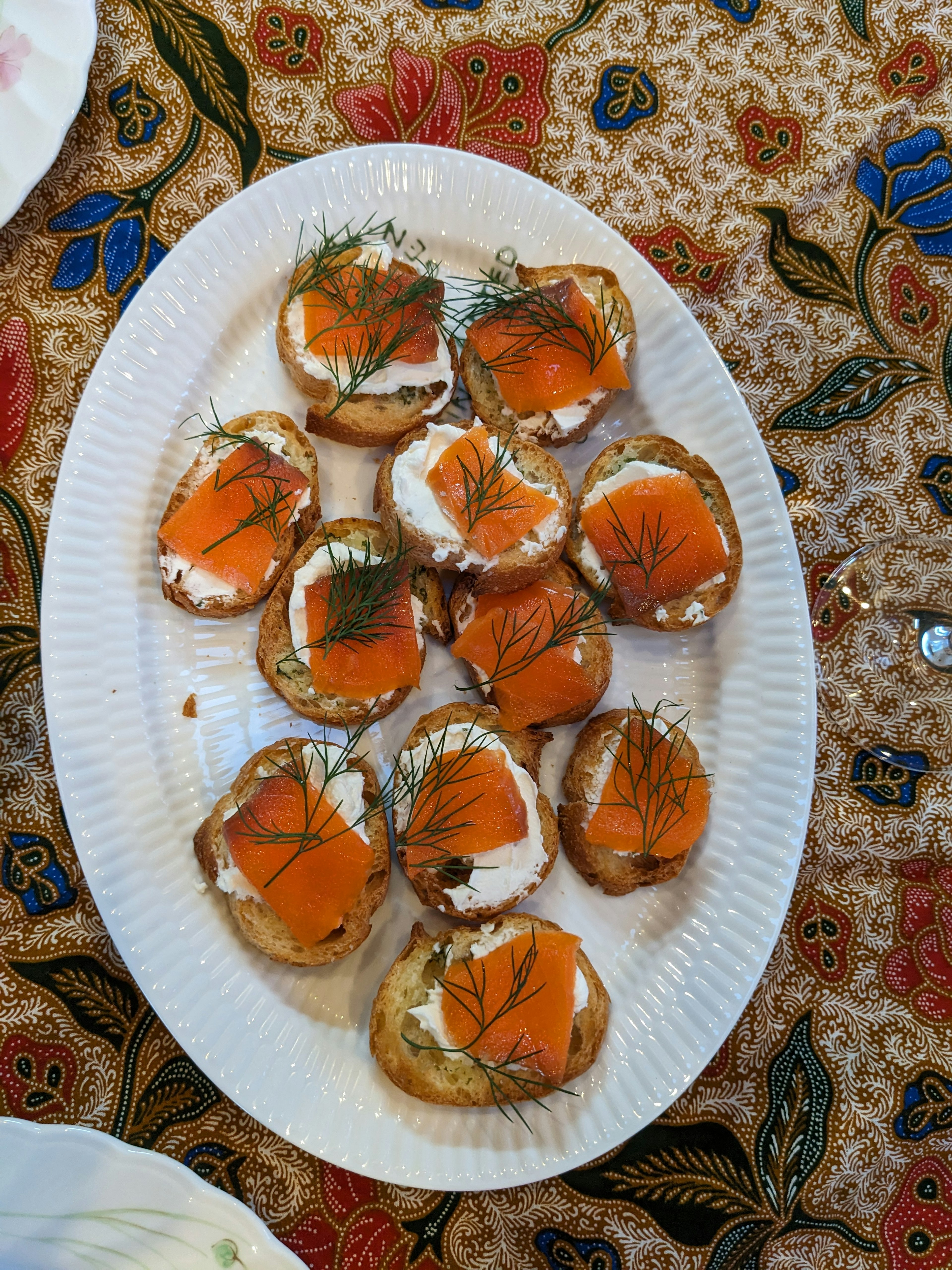 A platter of canapés topped with cream cheese and smoked salmon