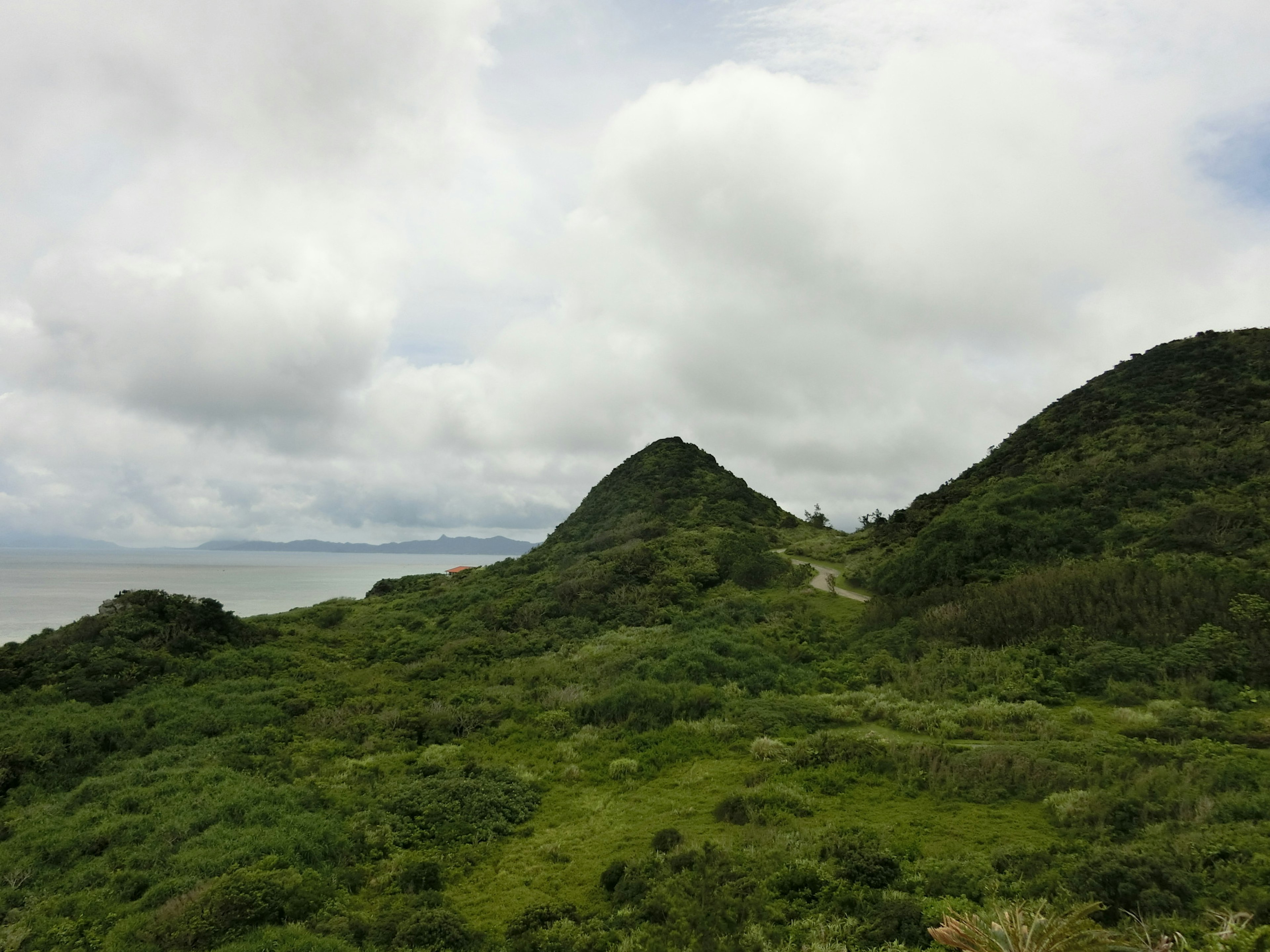 Scenic landscape with green hills and cloudy sky