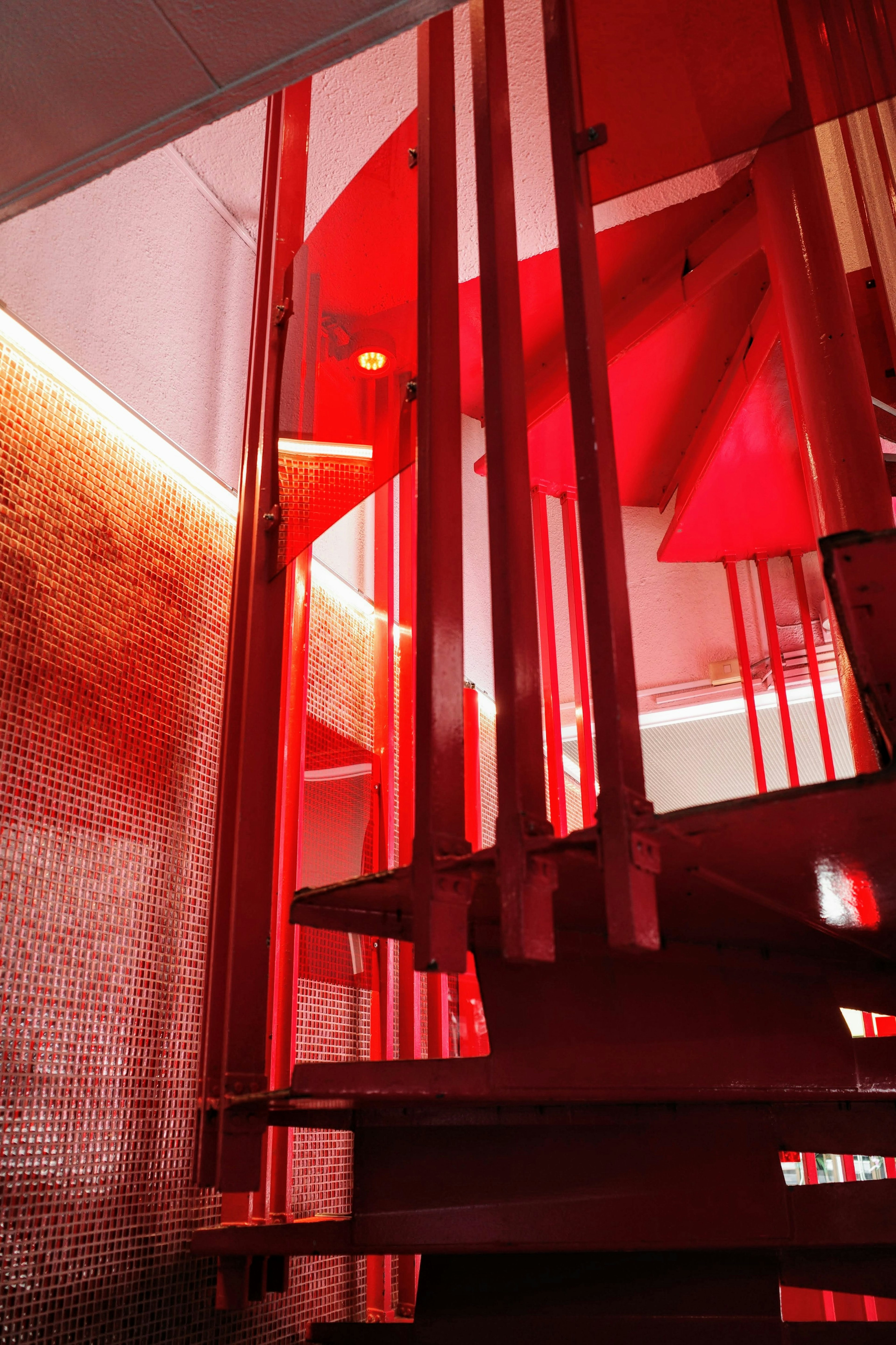 Modern space featuring red staircase and lighting