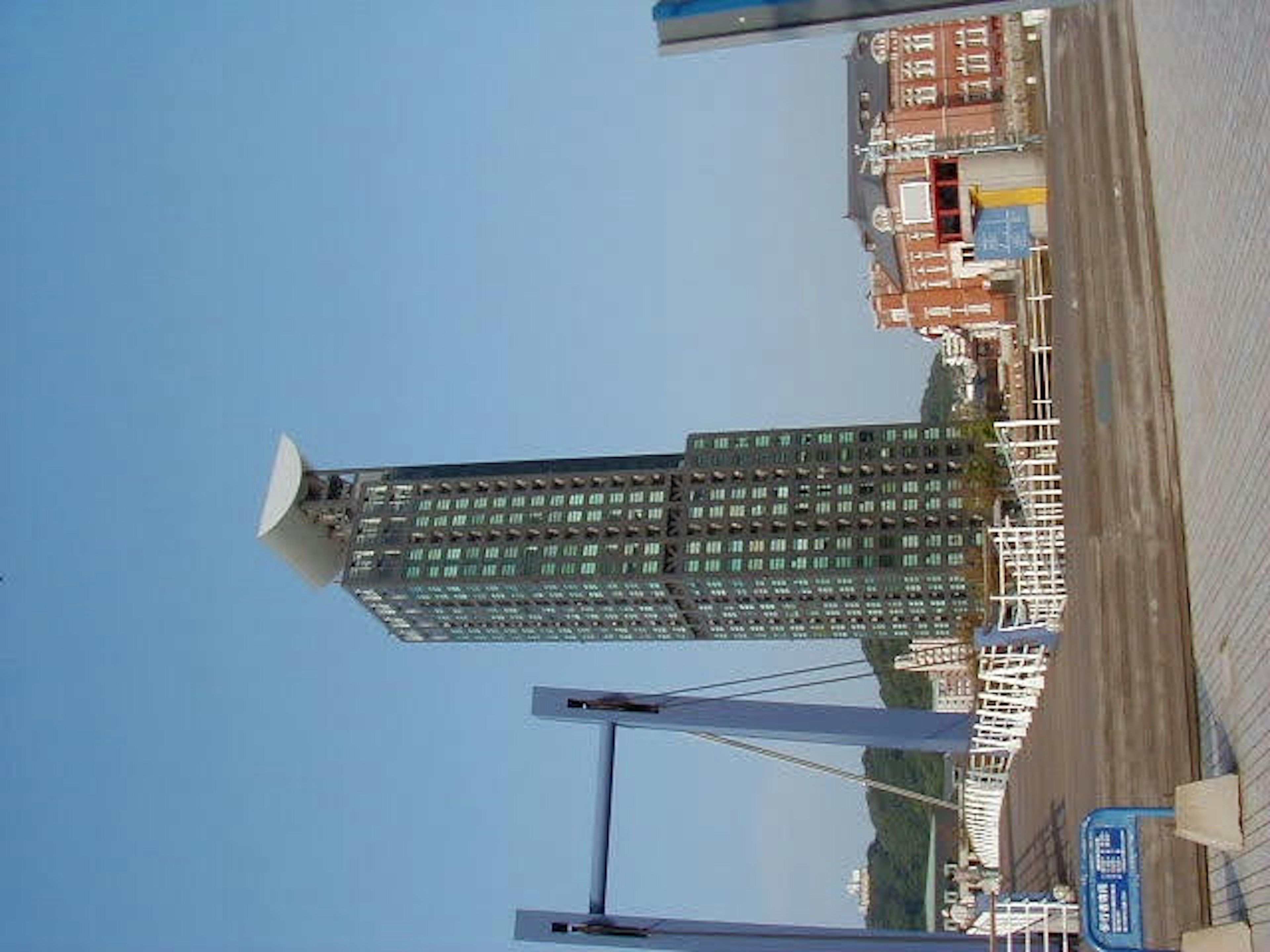 A tall glass building against a clear blue sky