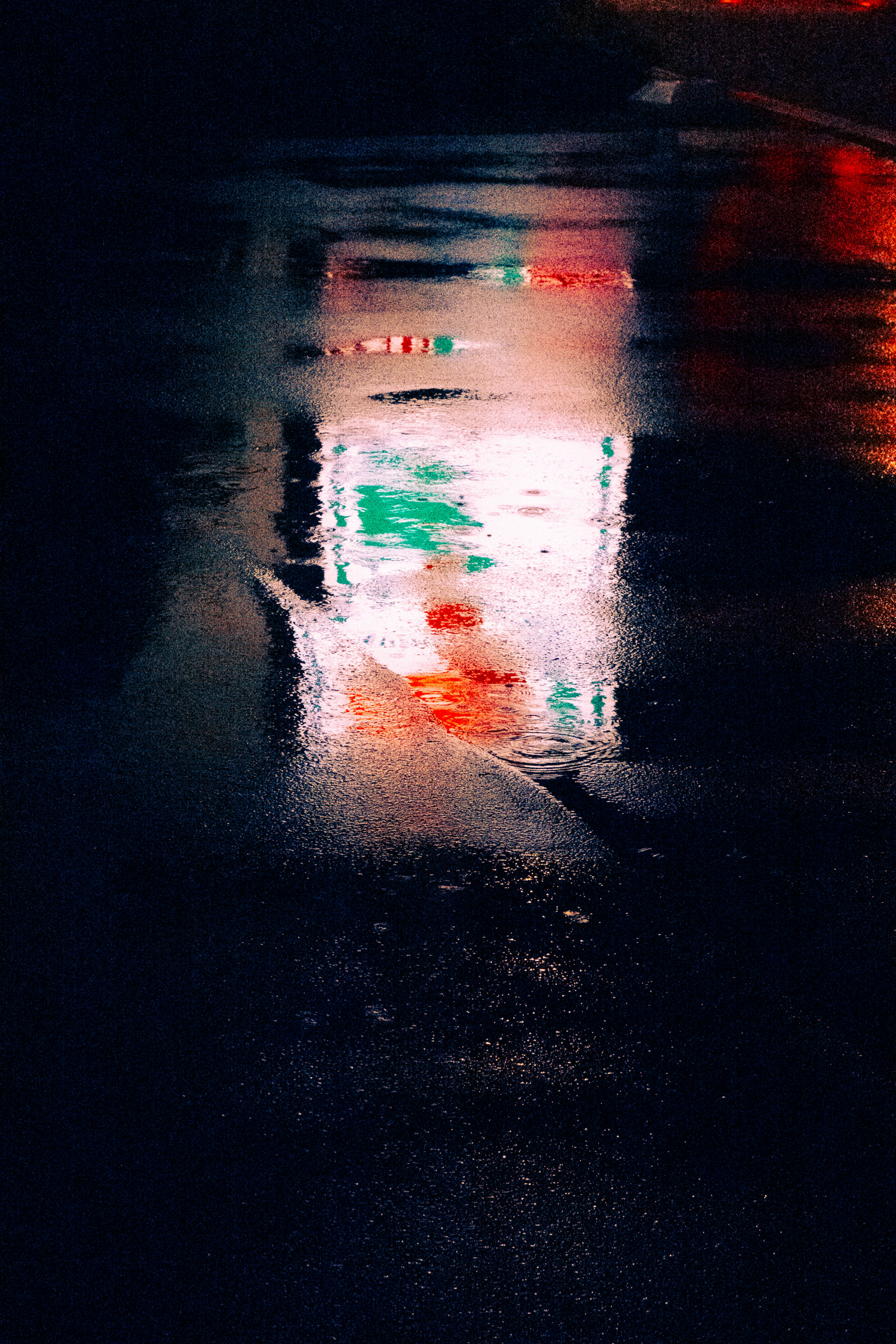 Colorful neon sign reflected on a wet surface