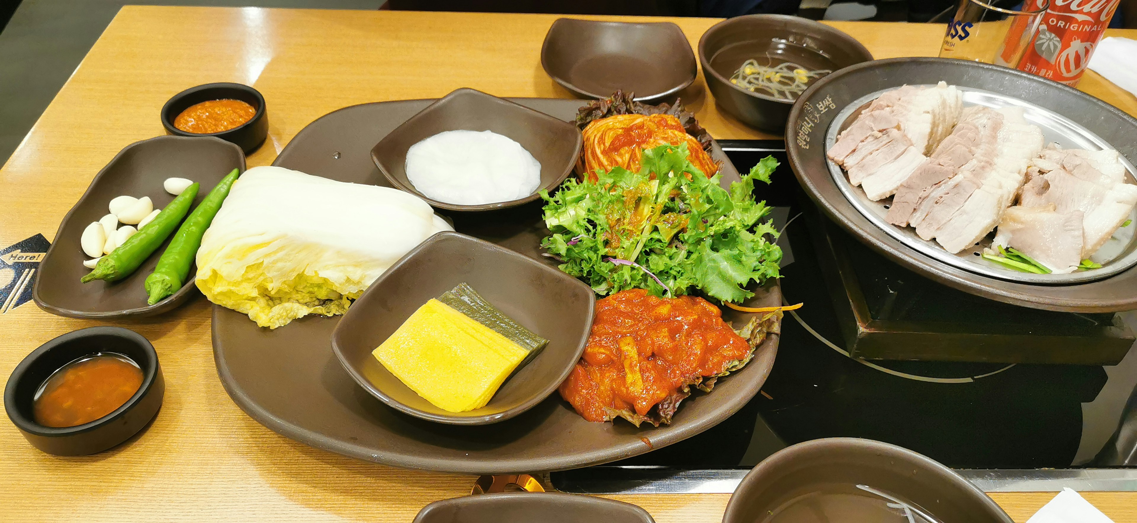 A platter of assorted dishes with grilled meat vegetables and sauces