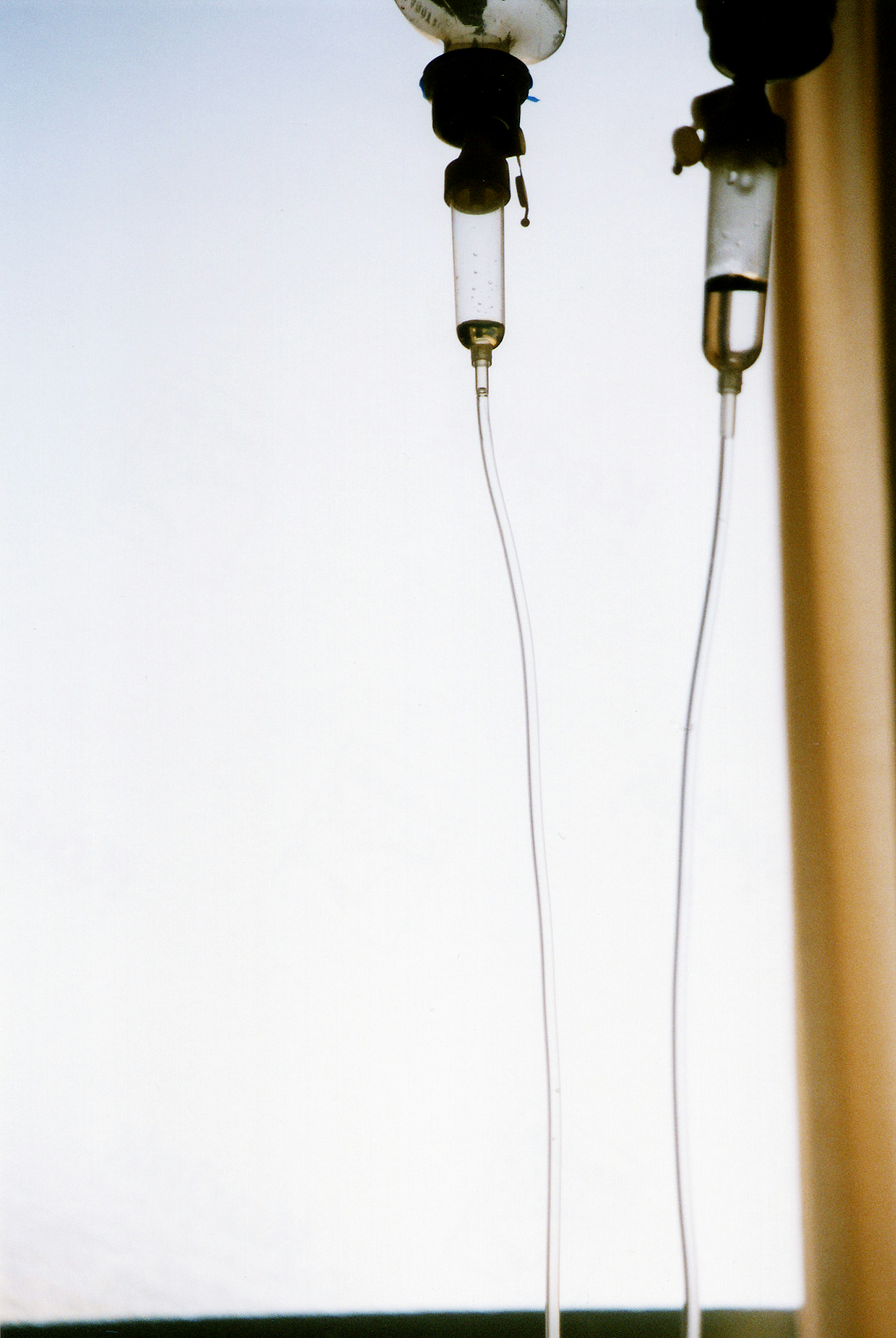 IV drips with clear tubes against a bright background