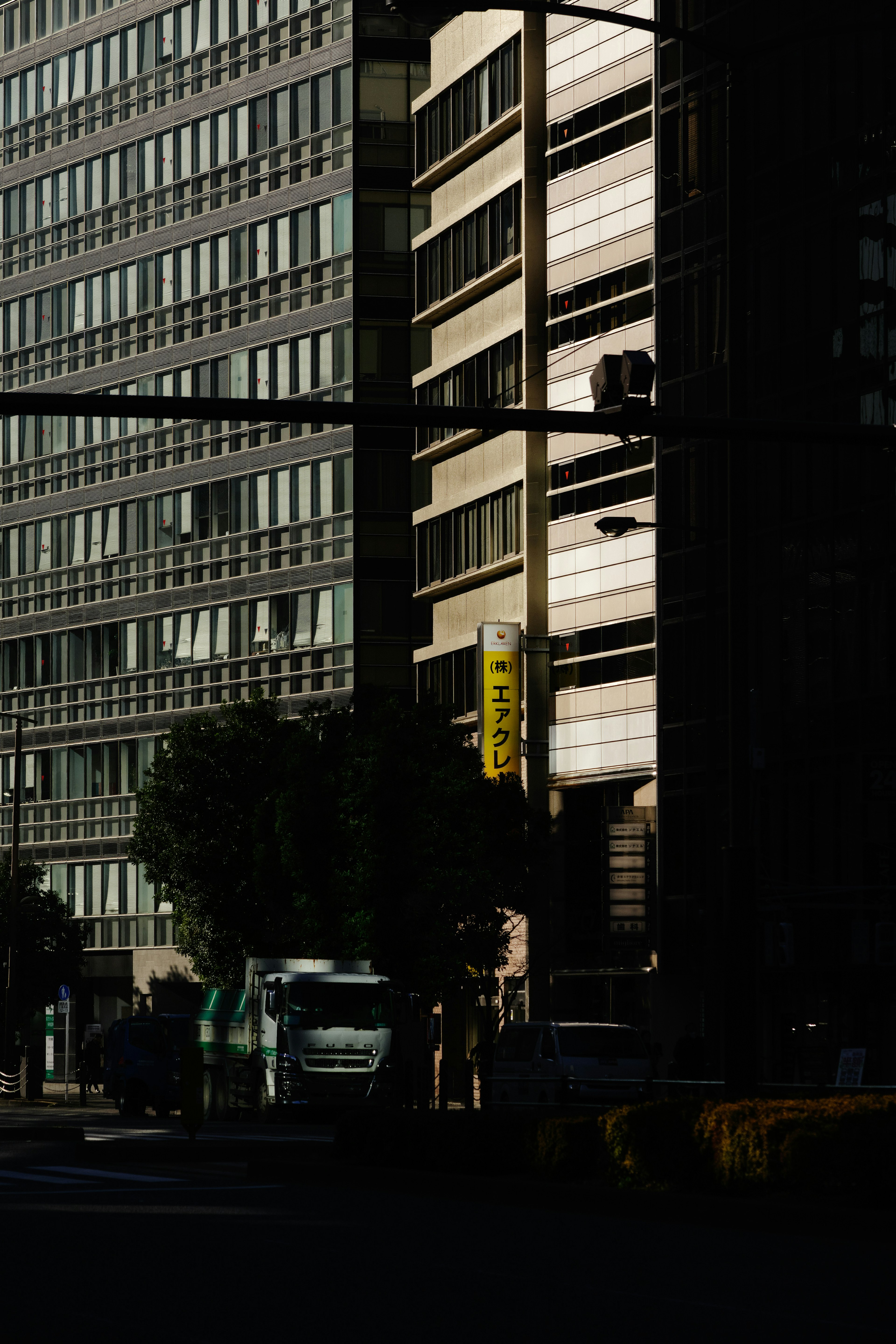 Urban landscape showcasing contrast of light and shadow on buildings