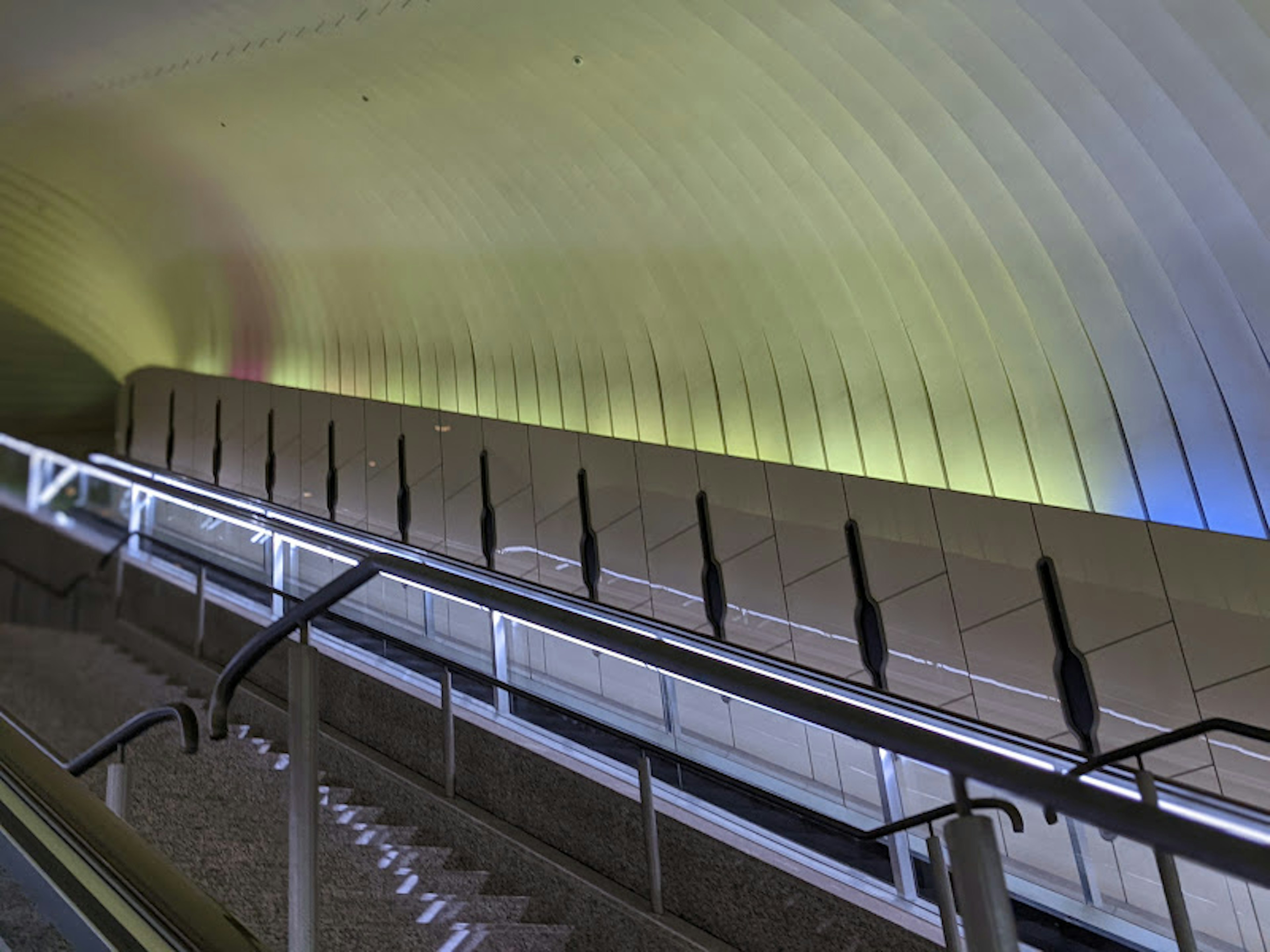 Interior of a modern building featuring a smooth curved ceiling and colorful lighting