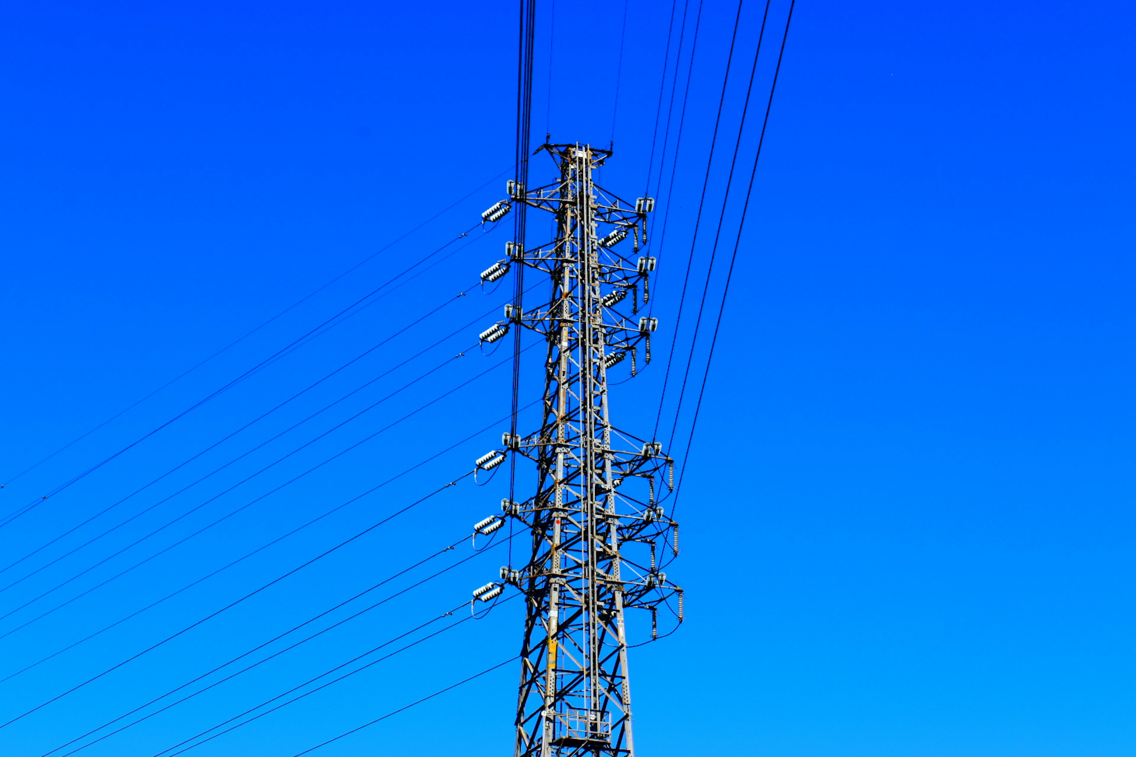 Electricity tower against a clear blue sky