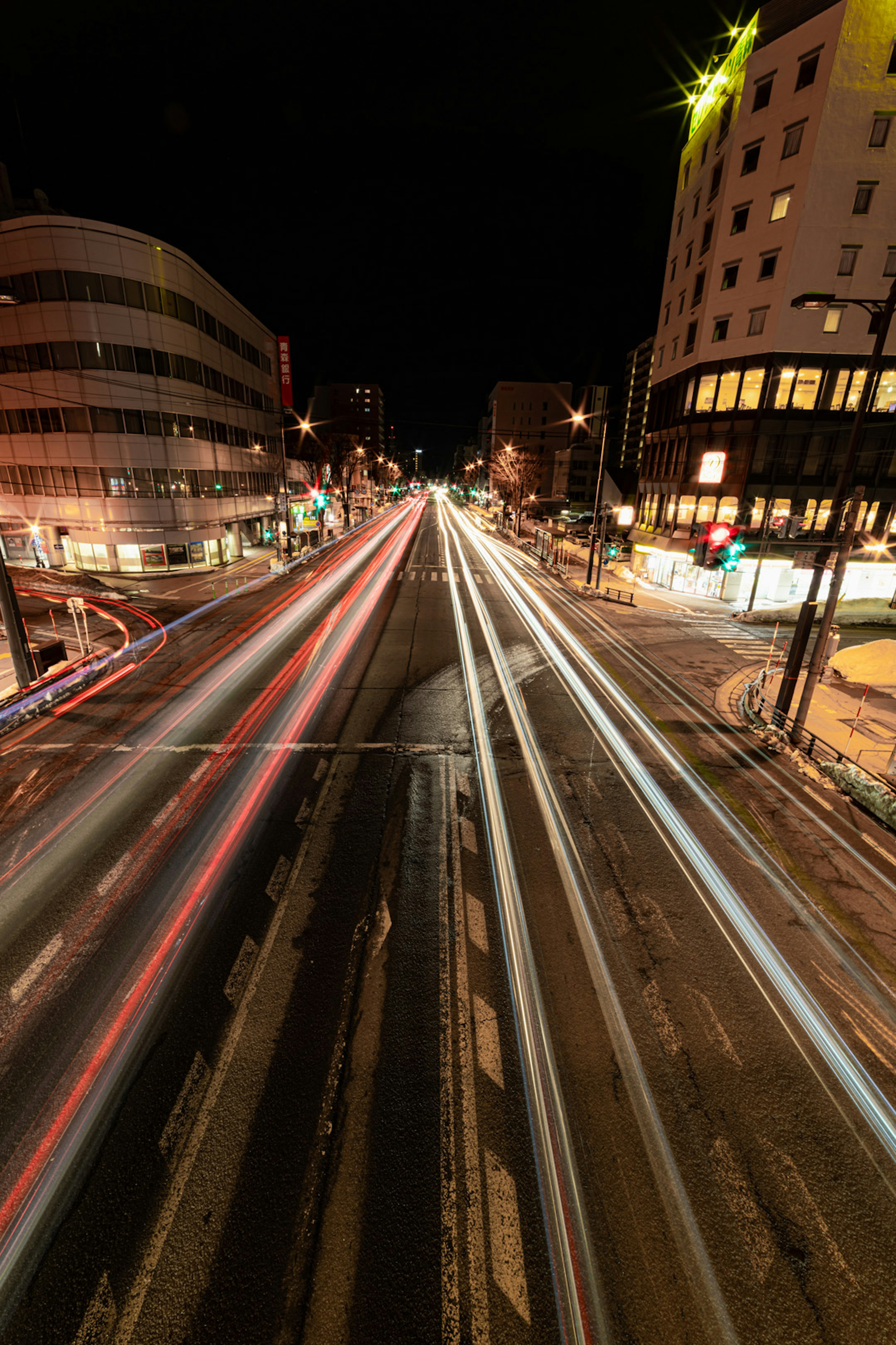 Eine Nachtszene mit hellen Lichtspuren auf einer belebten Straße