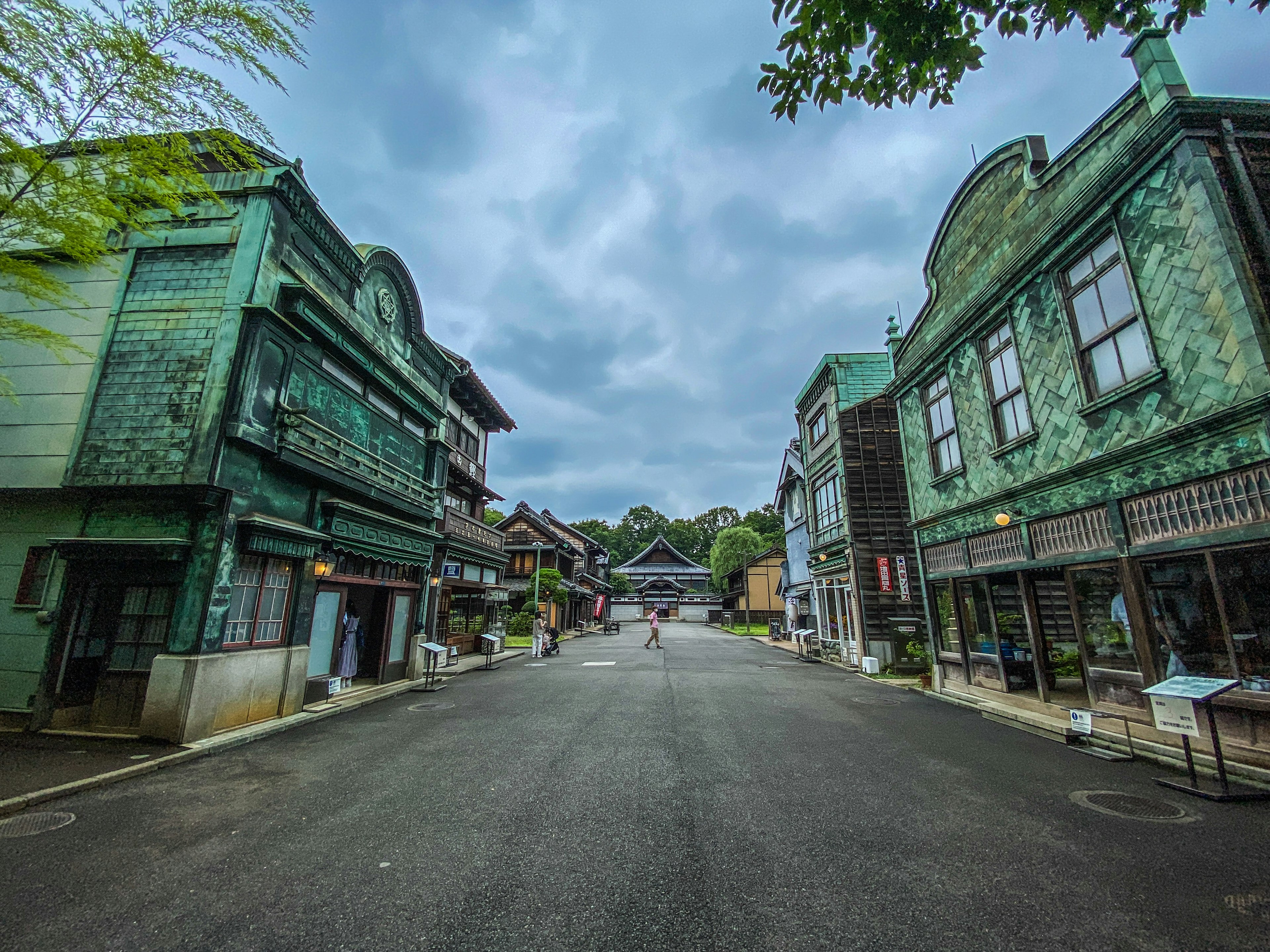 Quiet street scene with green vintage buildings