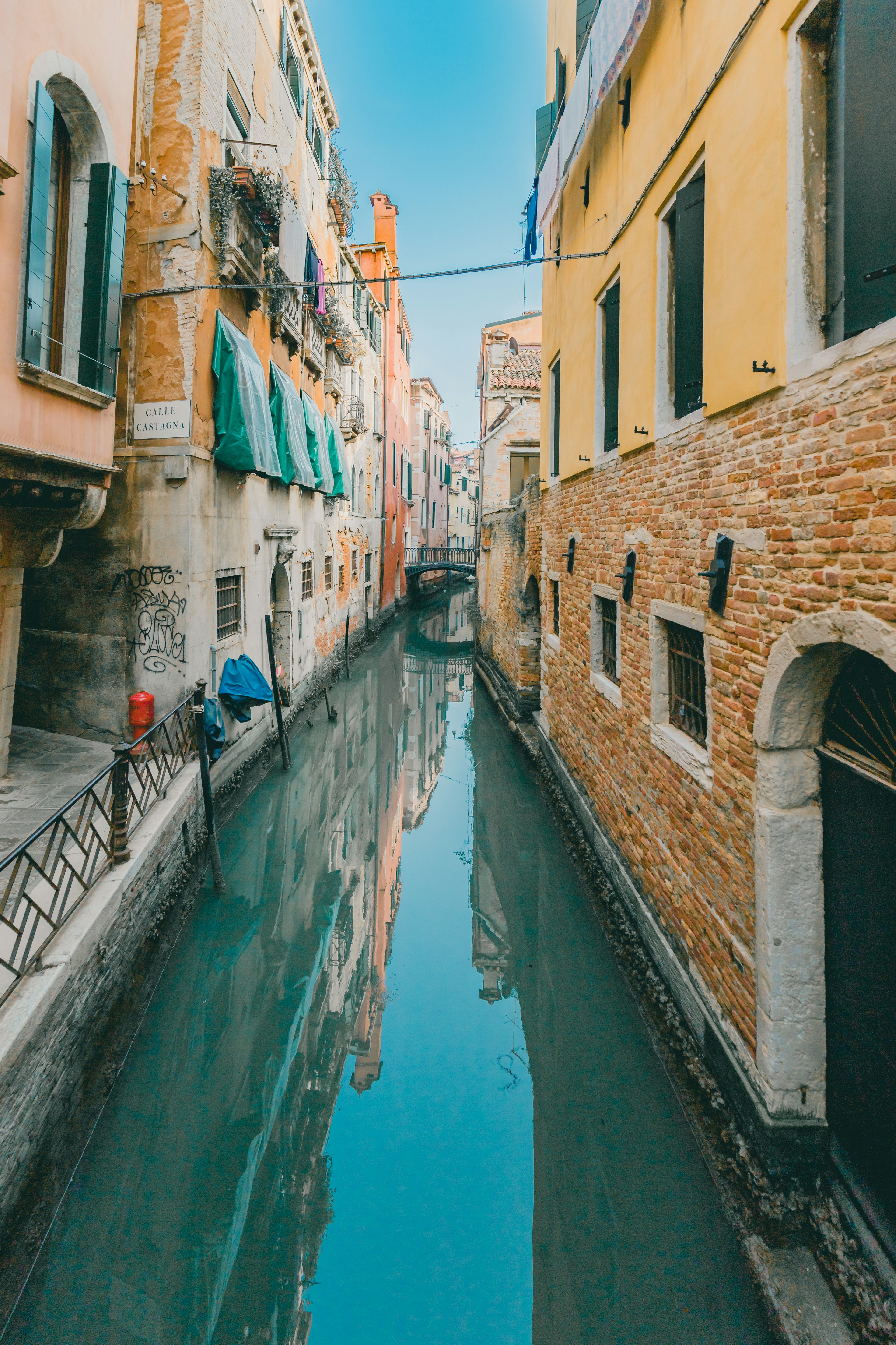 Venetian scene featuring colorful buildings along a blue canal