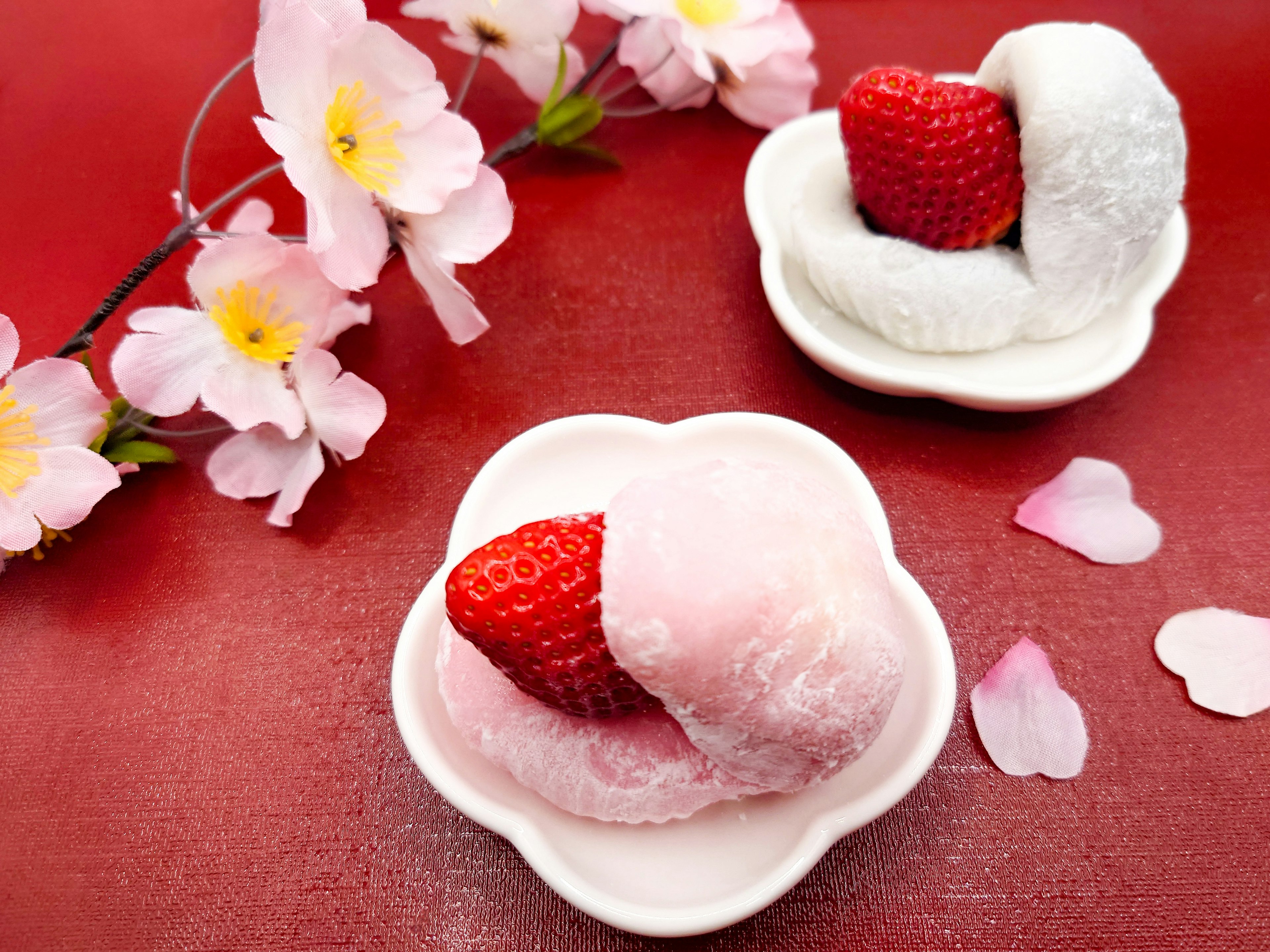 Beautiful arrangement of Japanese sweets with strawberries and cherry blossoms