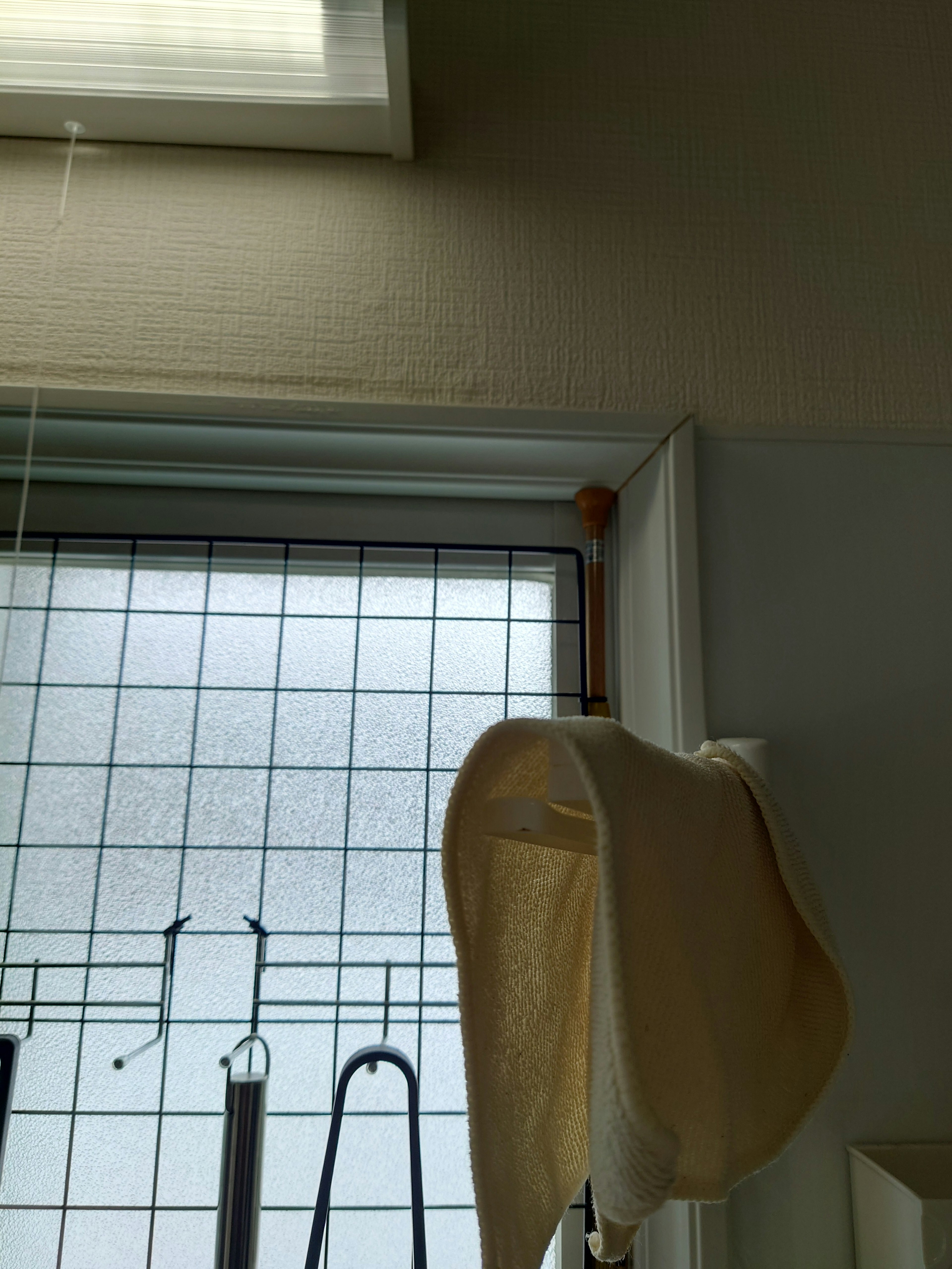 Photo of a window with a white curtain and a window frame