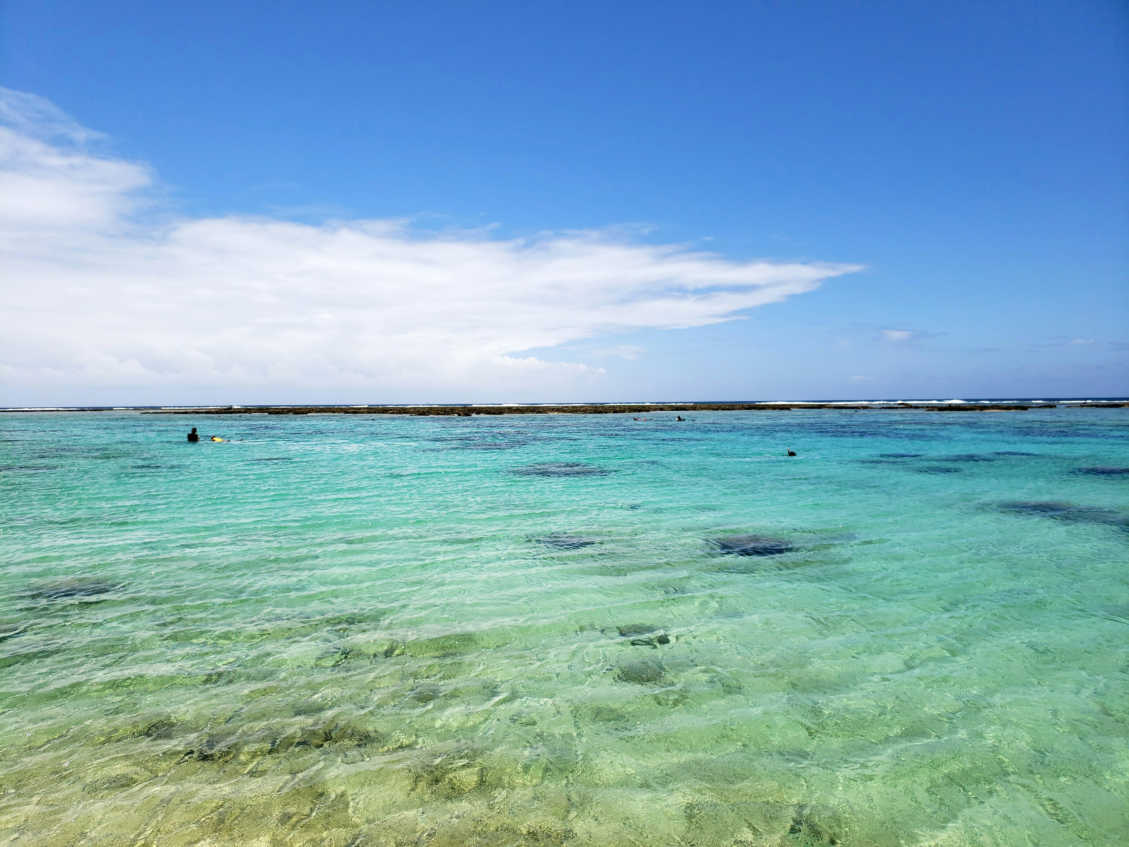 Vibrant turquoise sea under a clear blue sky