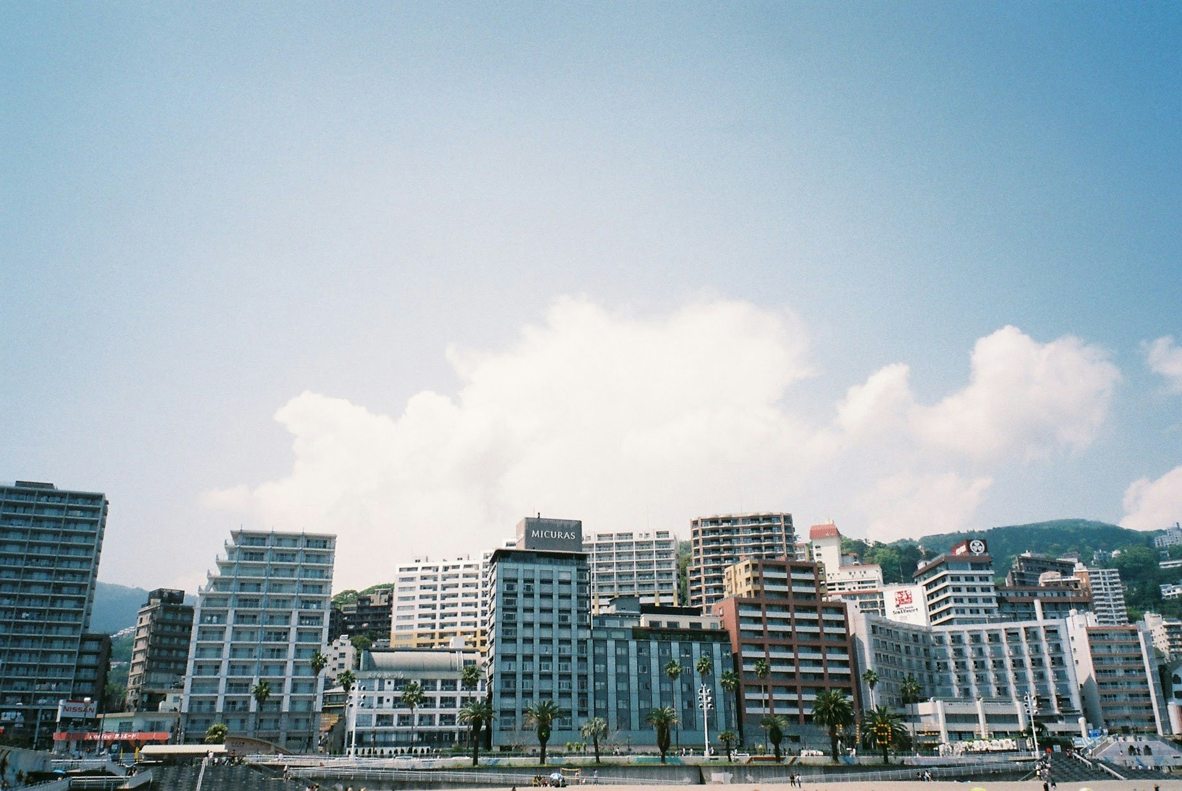 Modern skyscrapers along the waterfront under a clear blue sky