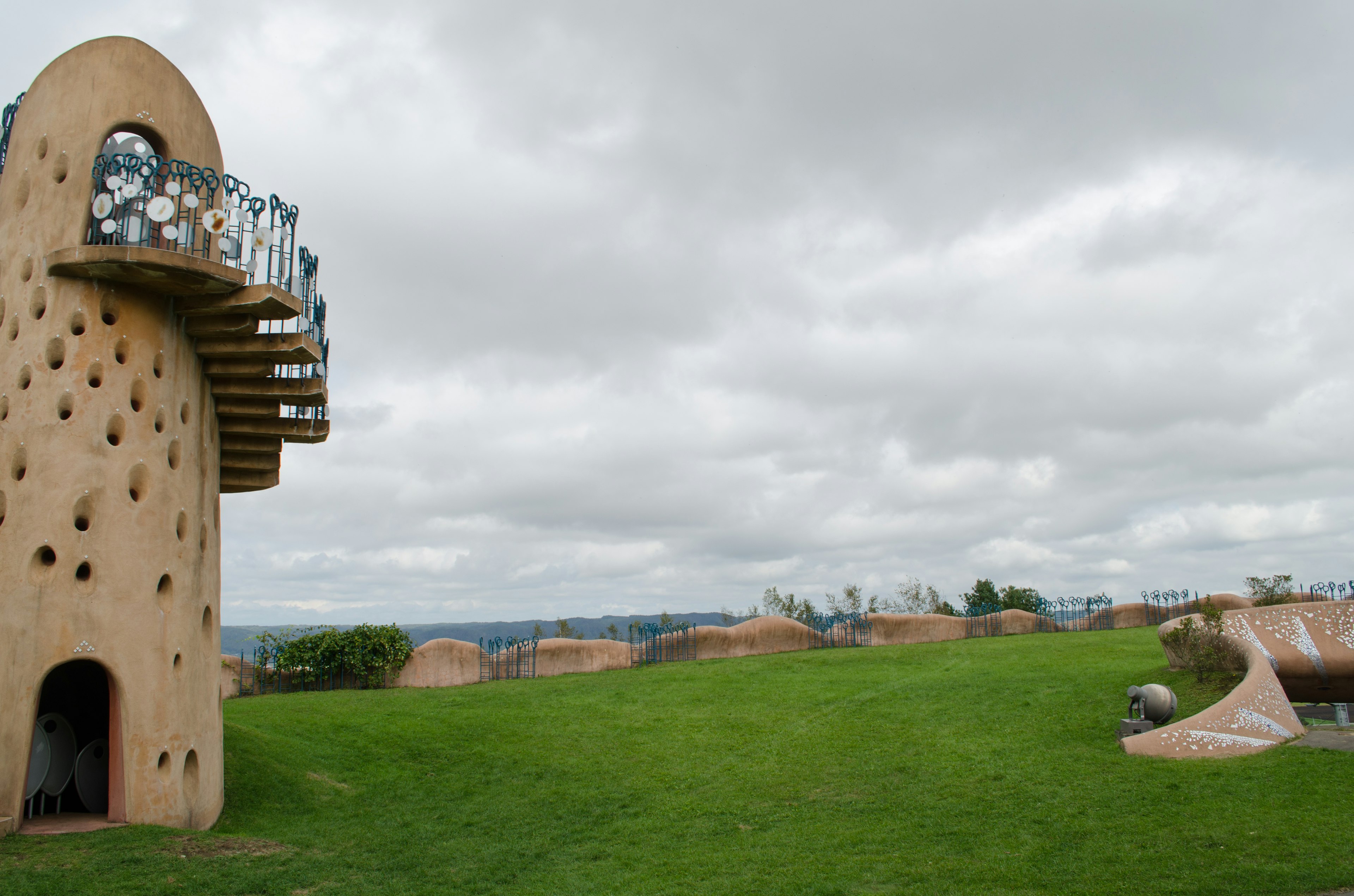 Curved architecture with unique design and green grass landscape