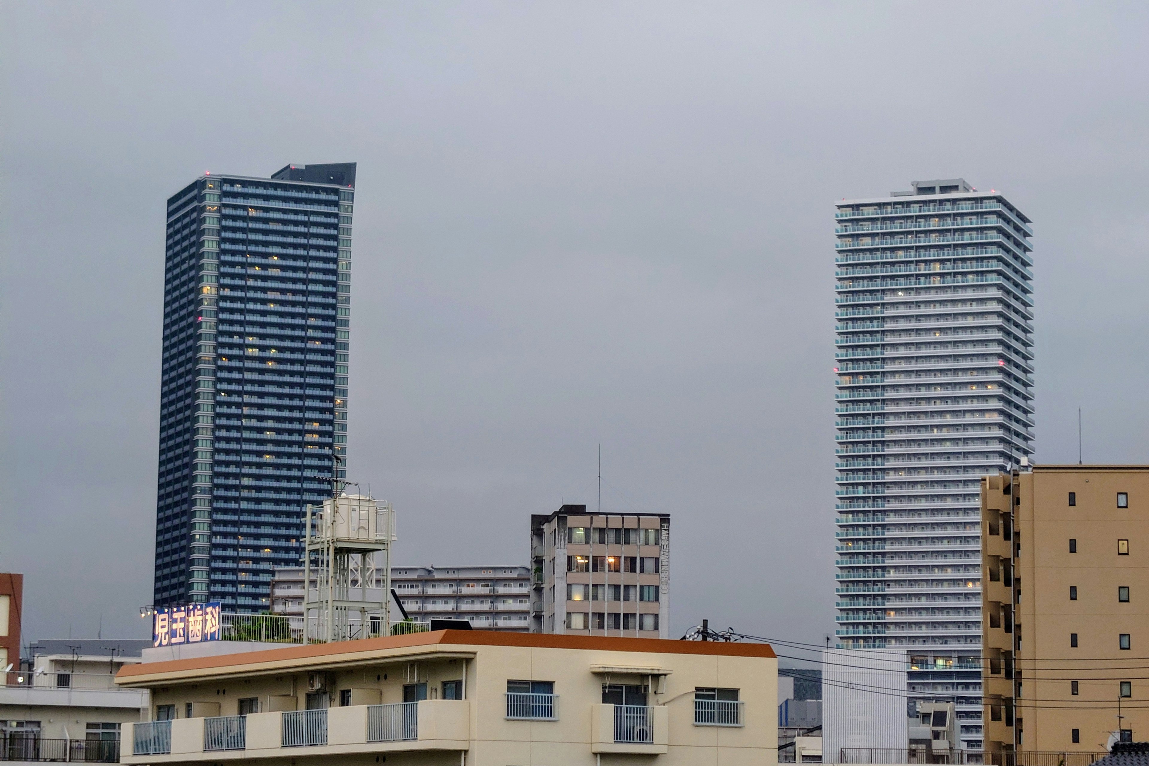 City skyline with tall buildings under a bright gray sky