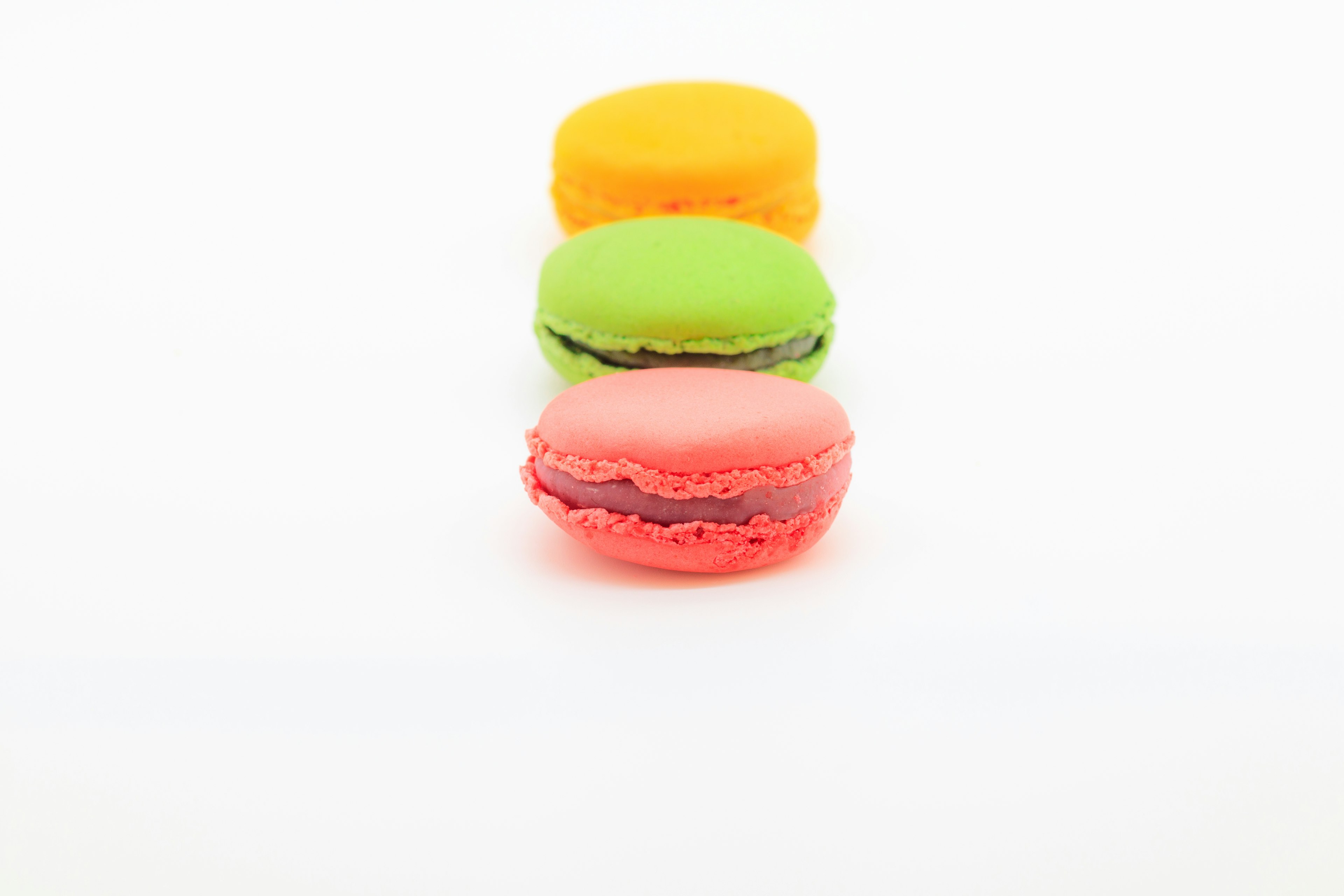 Colorful macarons arranged on a white background