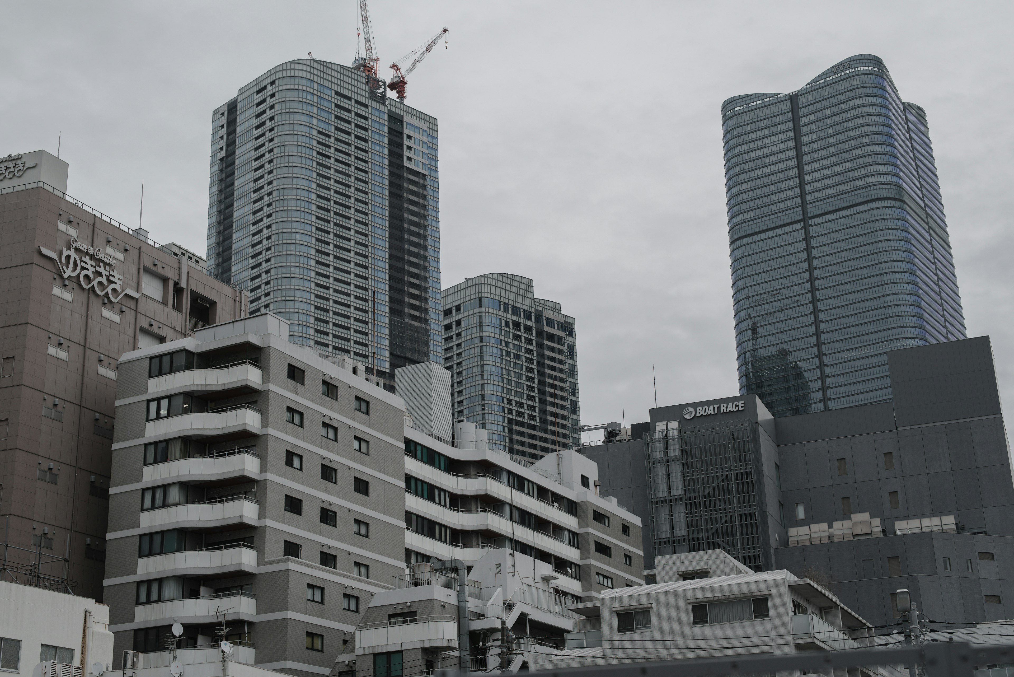 Urban landscape featuring skyscrapers and a construction crane