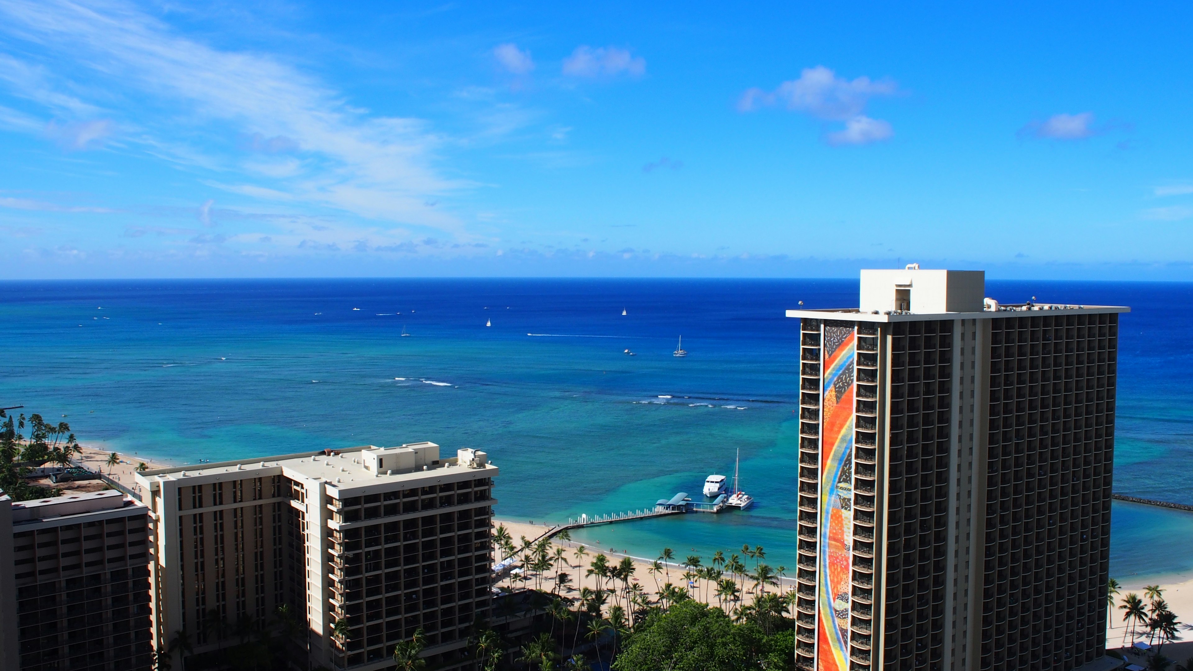 View of high-rise buildings with a blue ocean and clear sky