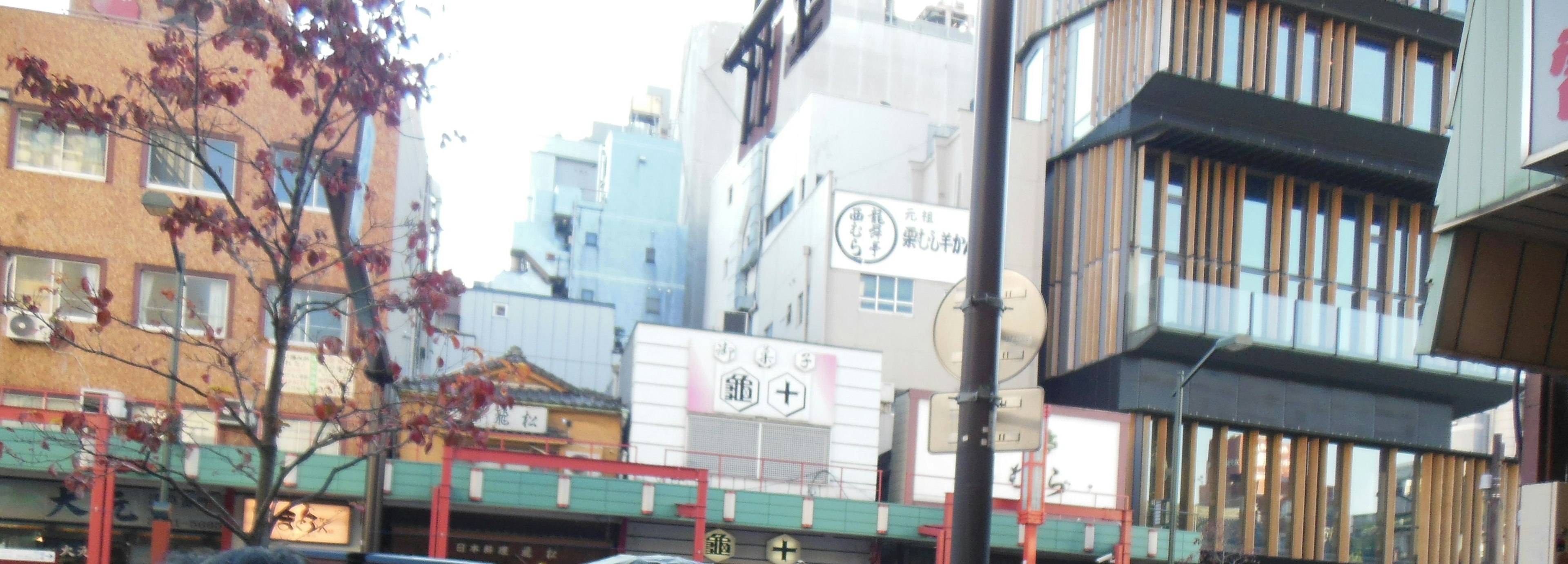 Urban street scene featuring modern buildings and storefronts