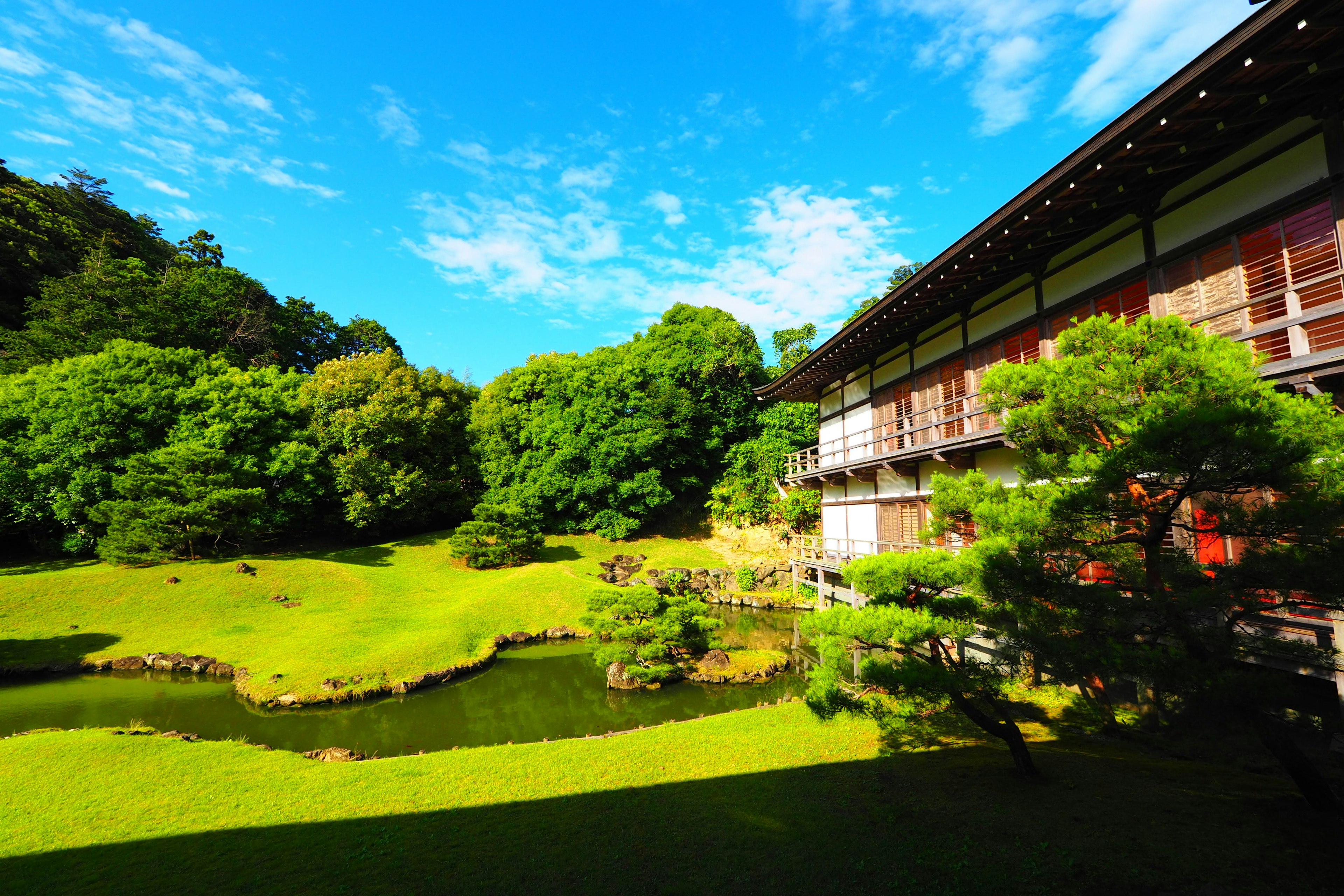 緑豊かな庭園と伝統的な建物がある風景