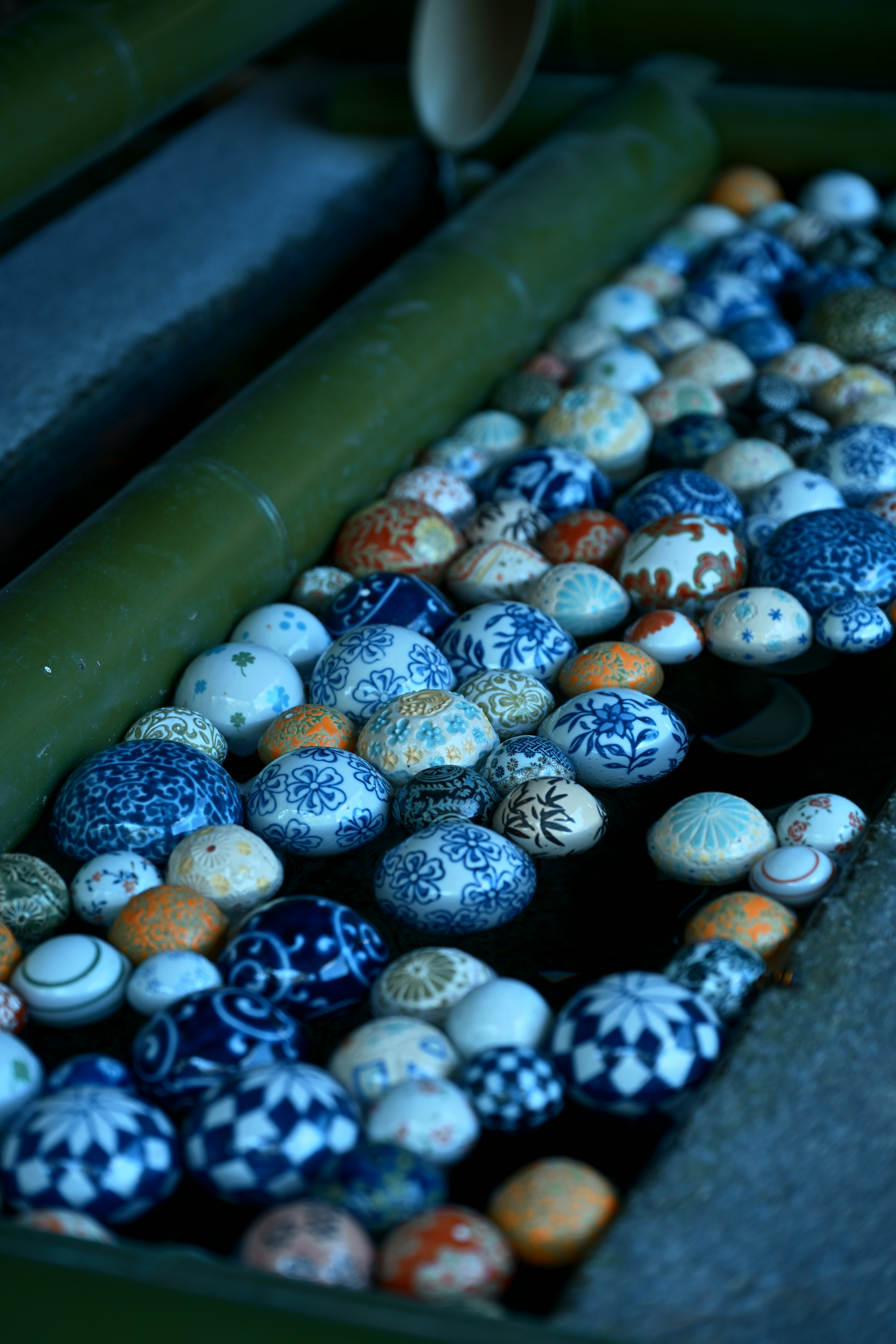 A collection of blue patterned eggs in water