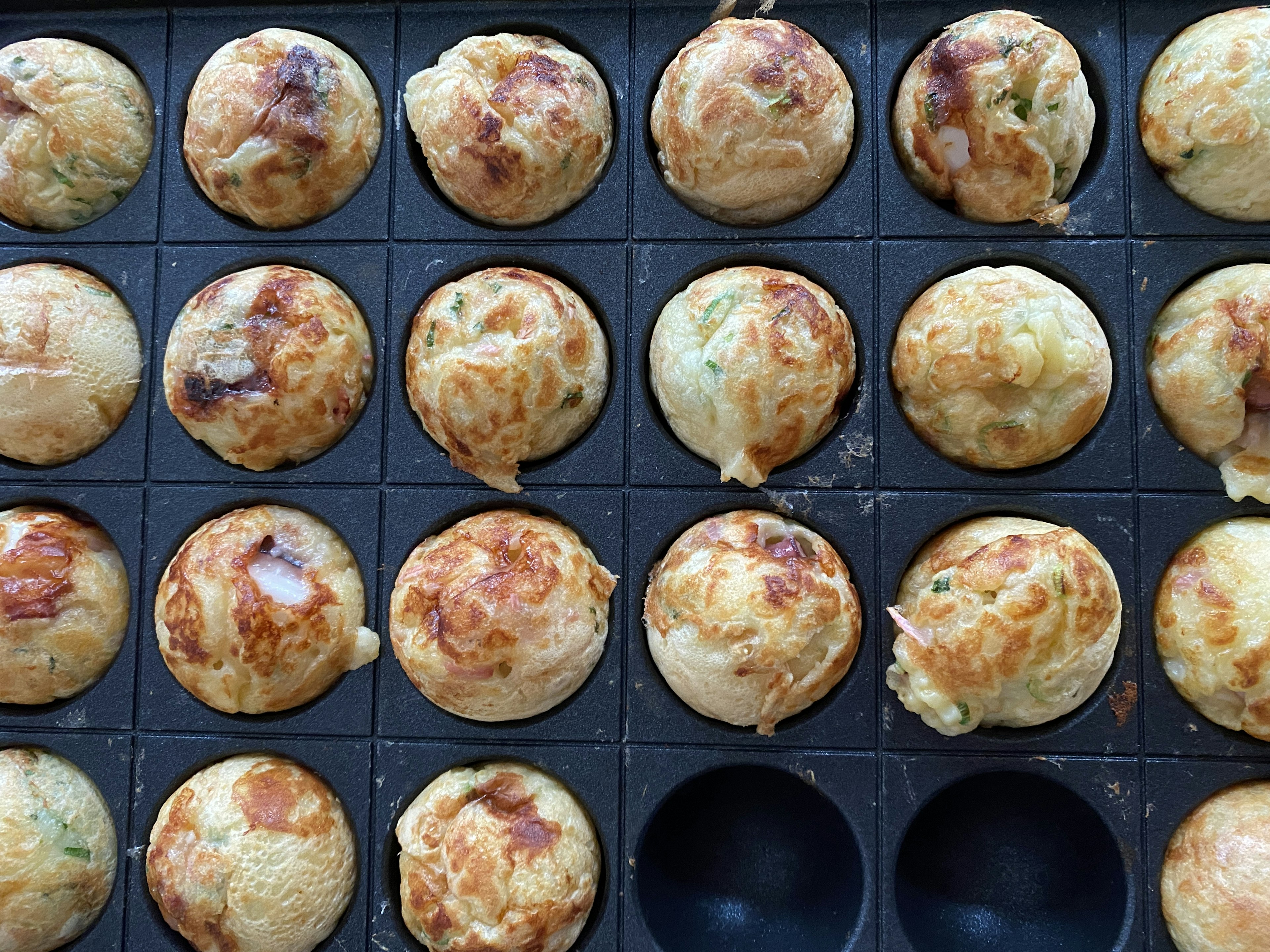 Freshly cooked takoyaki arranged in a tray