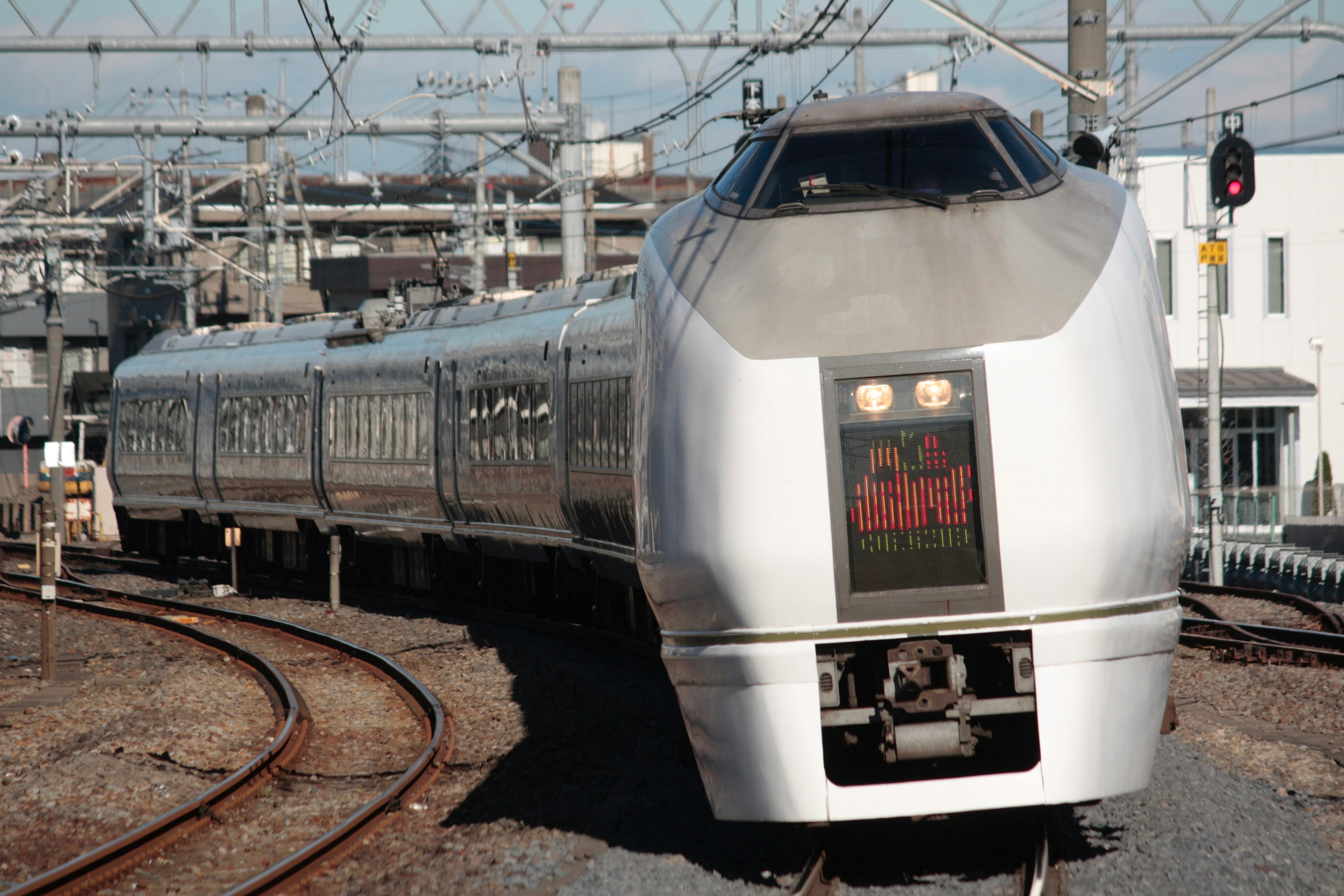 Silver Shinkansen train rounding a curve