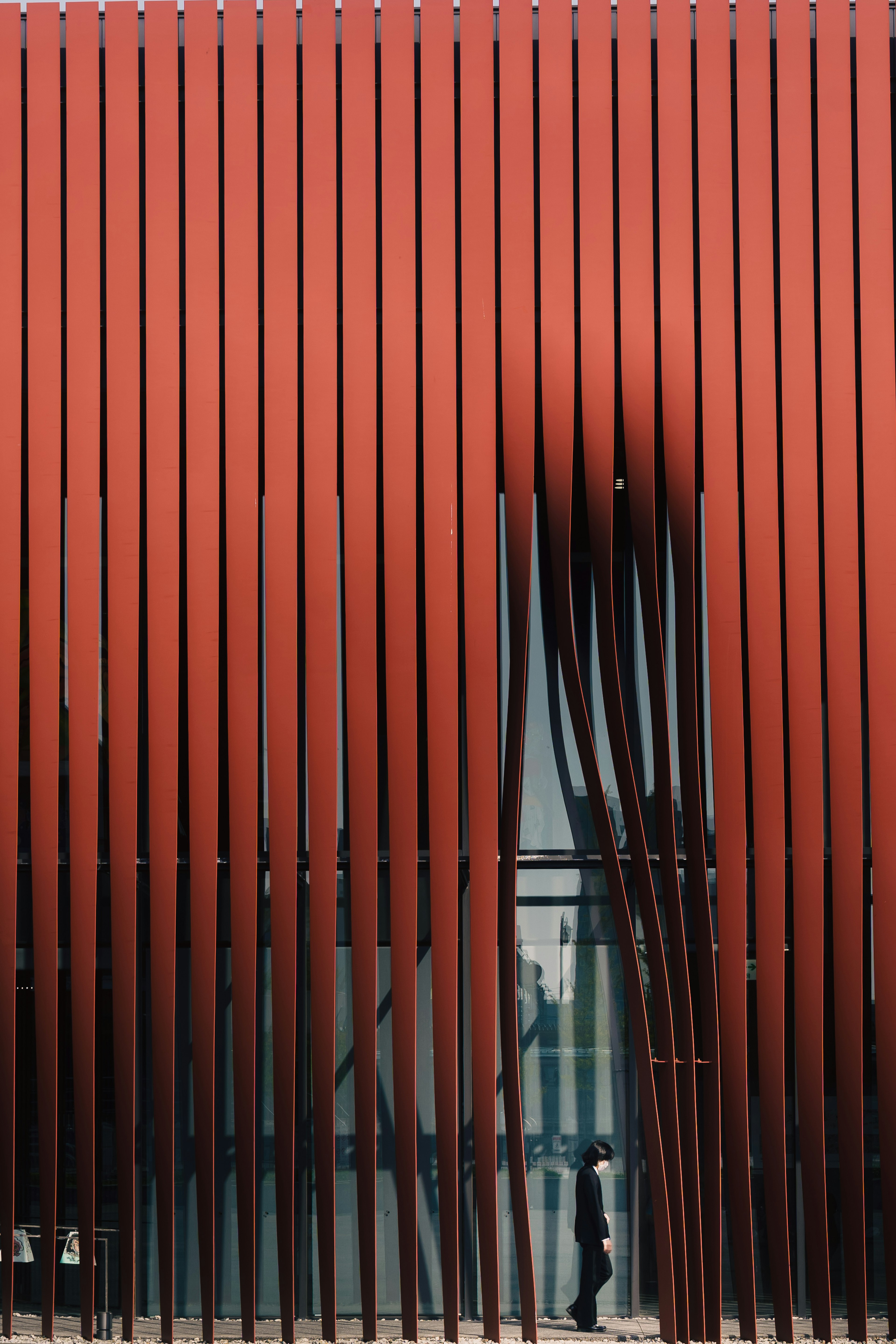 Exterior of a building with distinctive red vertical slats