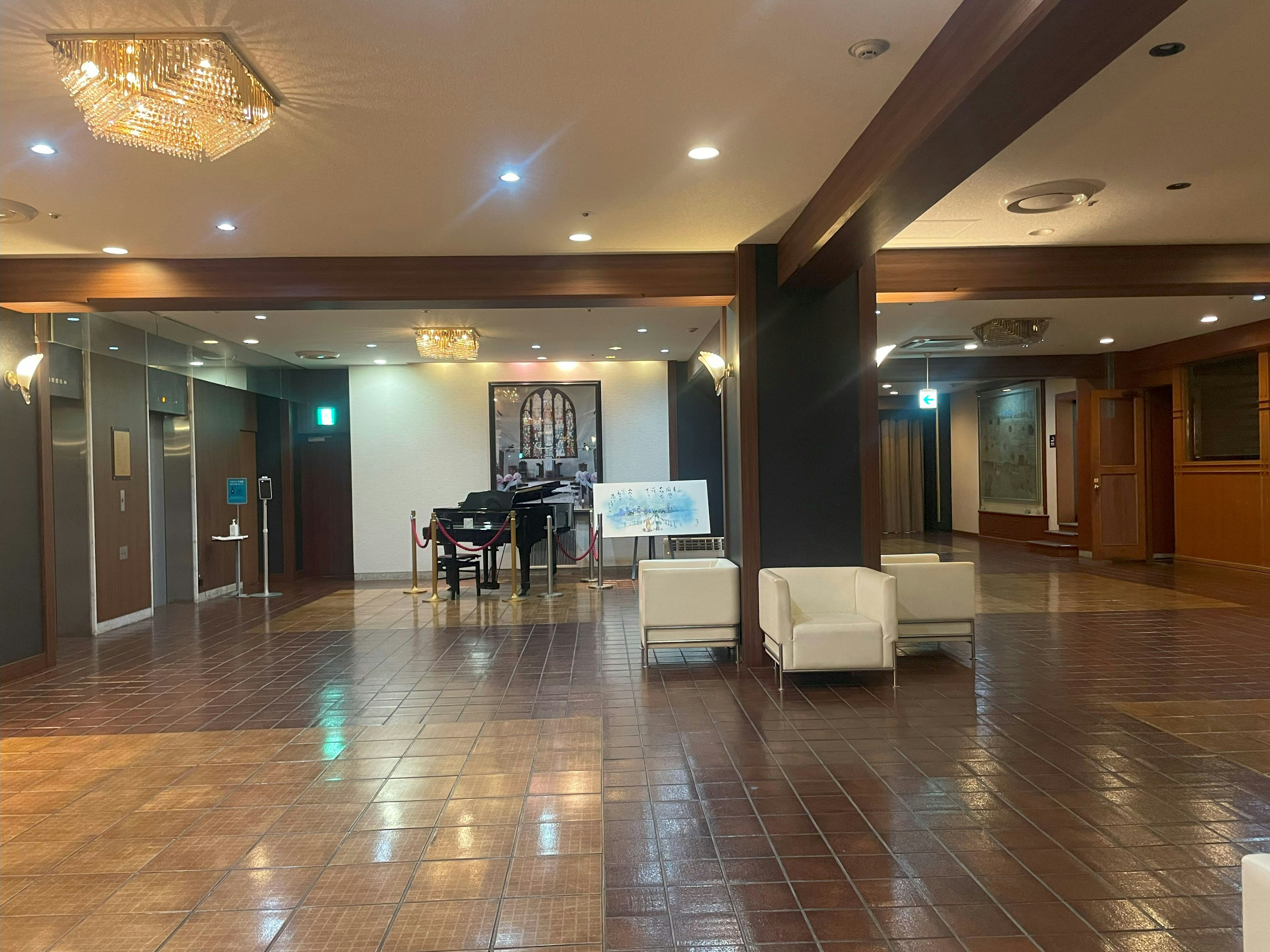 Spacious lobby featuring a piano and white sofas