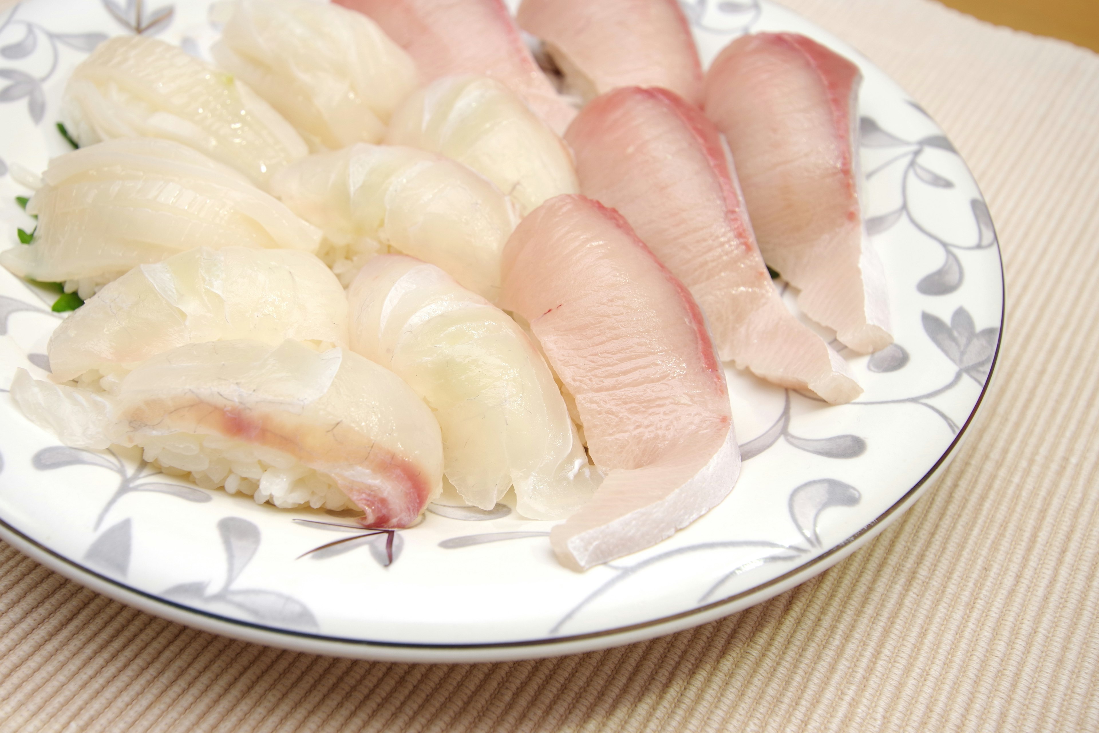 Platter of sushi featuring white fish slices