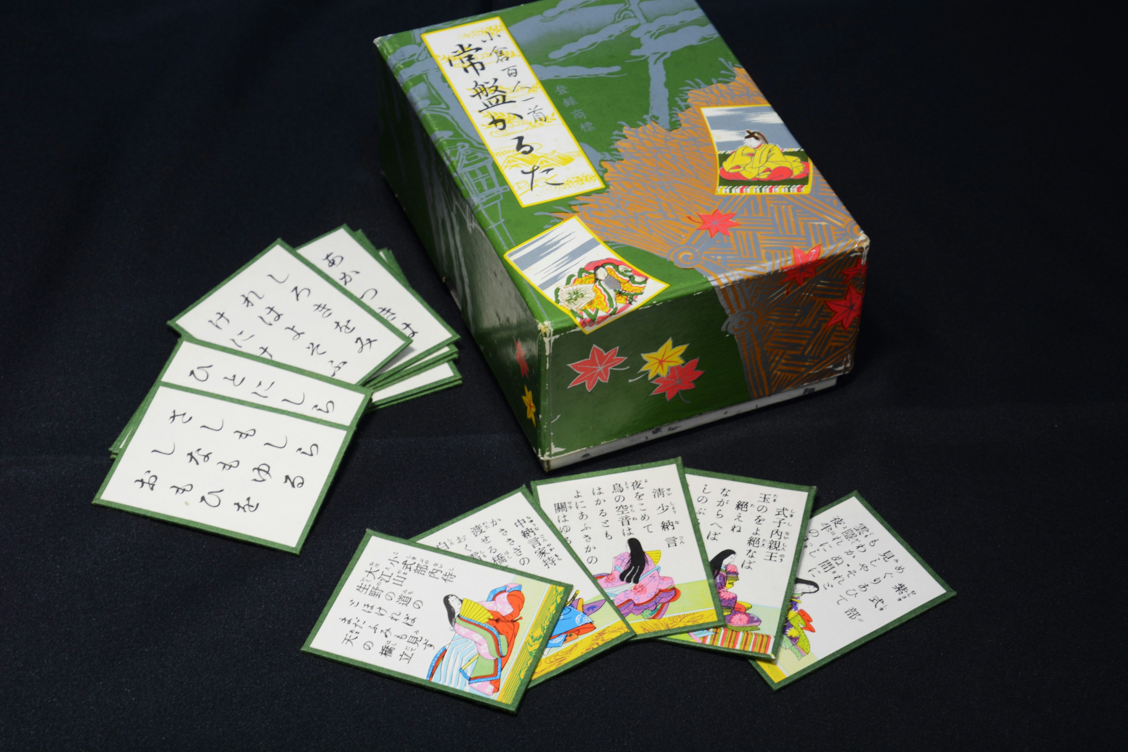 Colorful card set with a box displayed on a black background