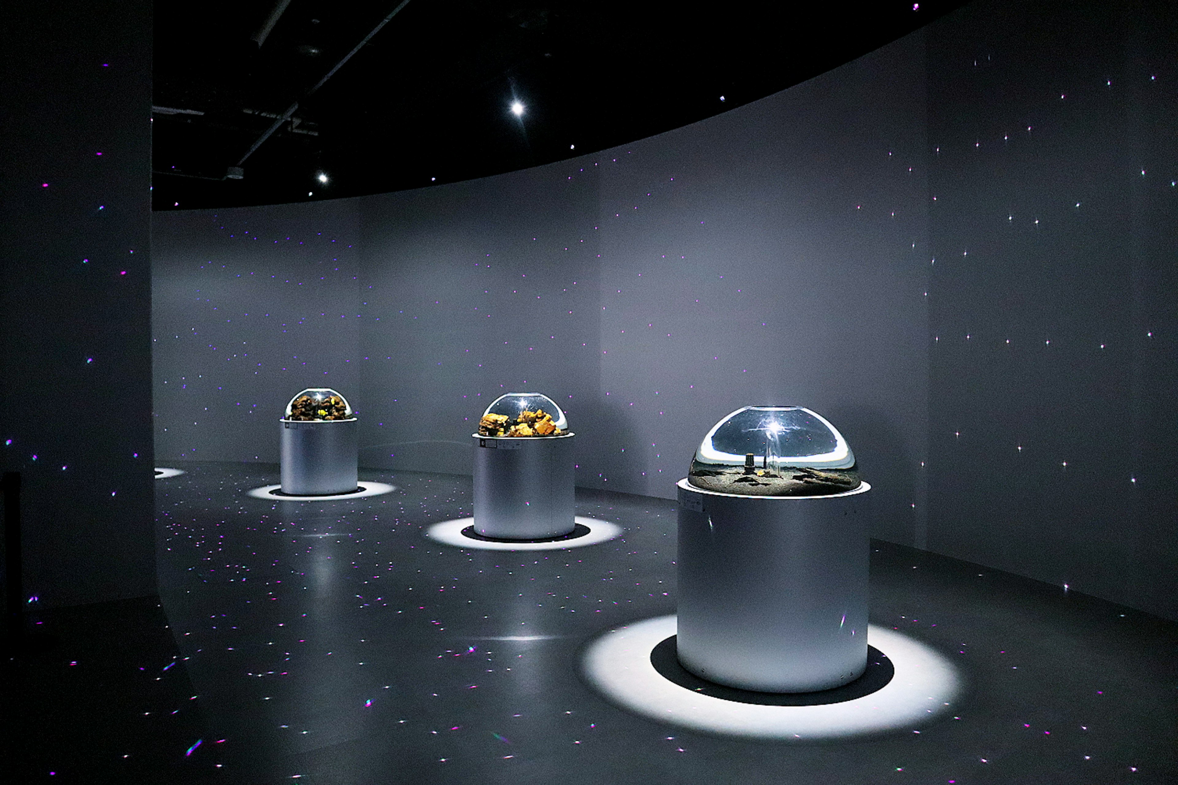 Futuristic exhibition space with transparent dome objects and lighting