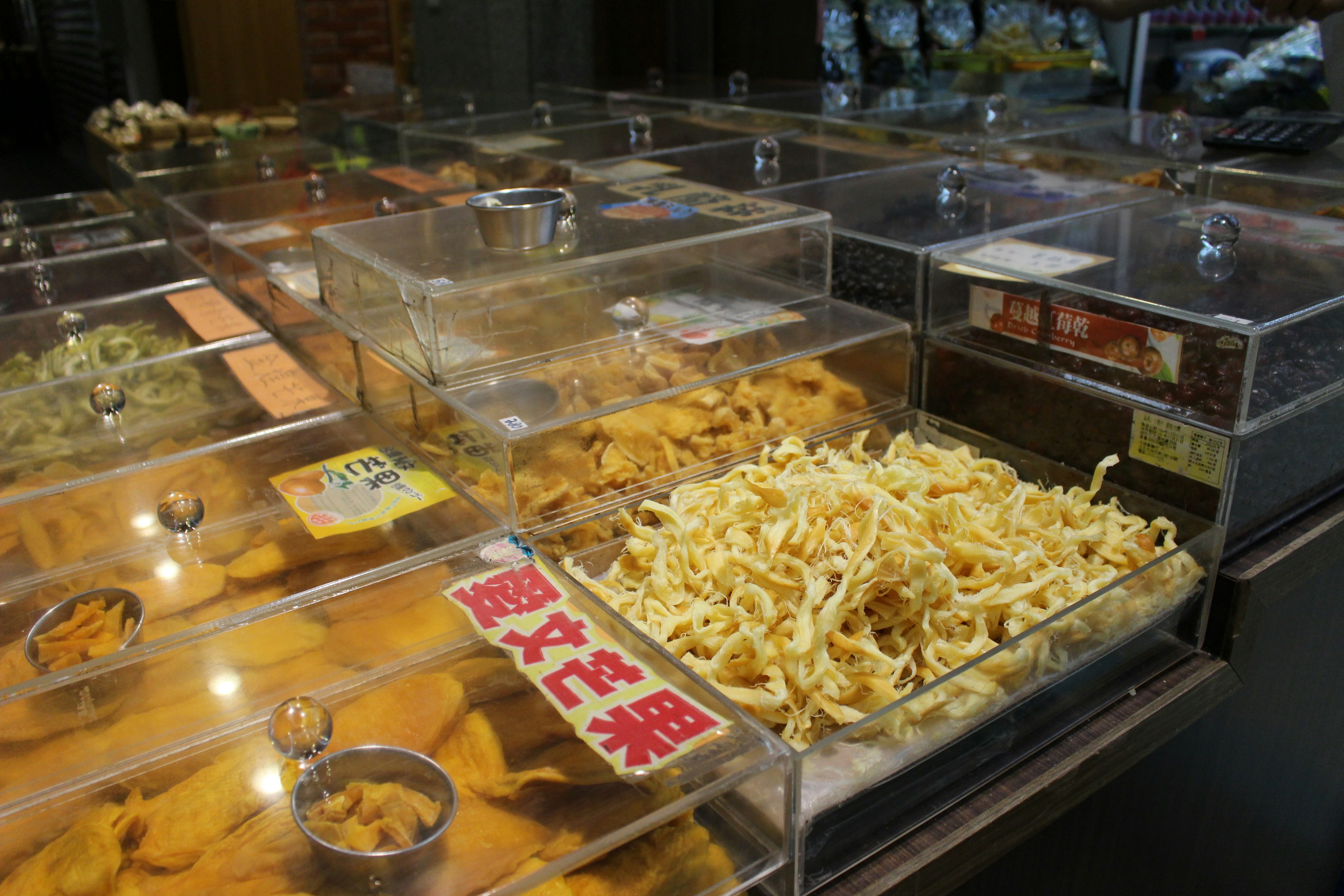 Display of various snacks and sweets in transparent containers