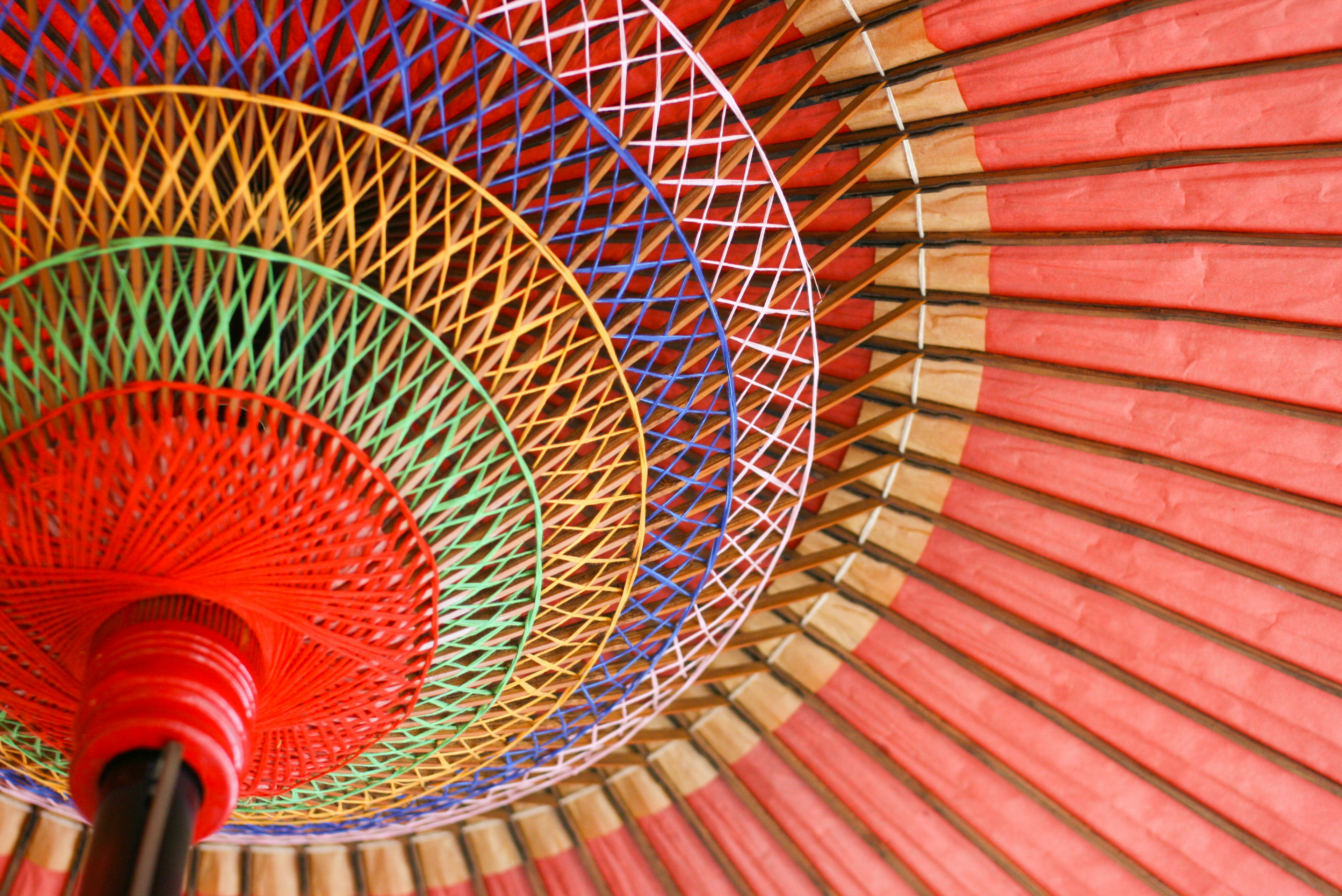 Colorful interior design of a traditional umbrella featuring a red exterior and multicolored patterns