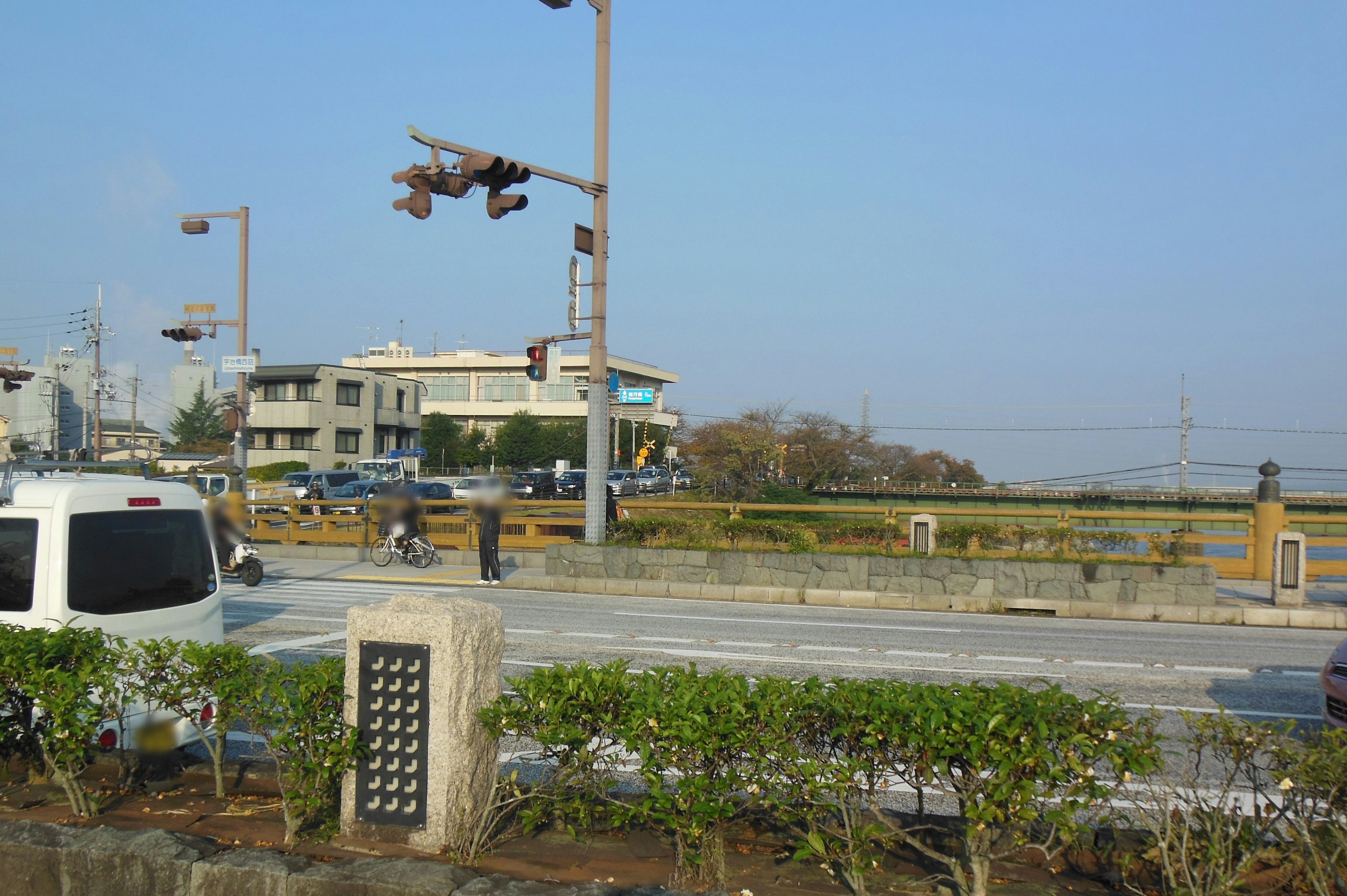 Intersection view with cars and traffic signals buildings and open road