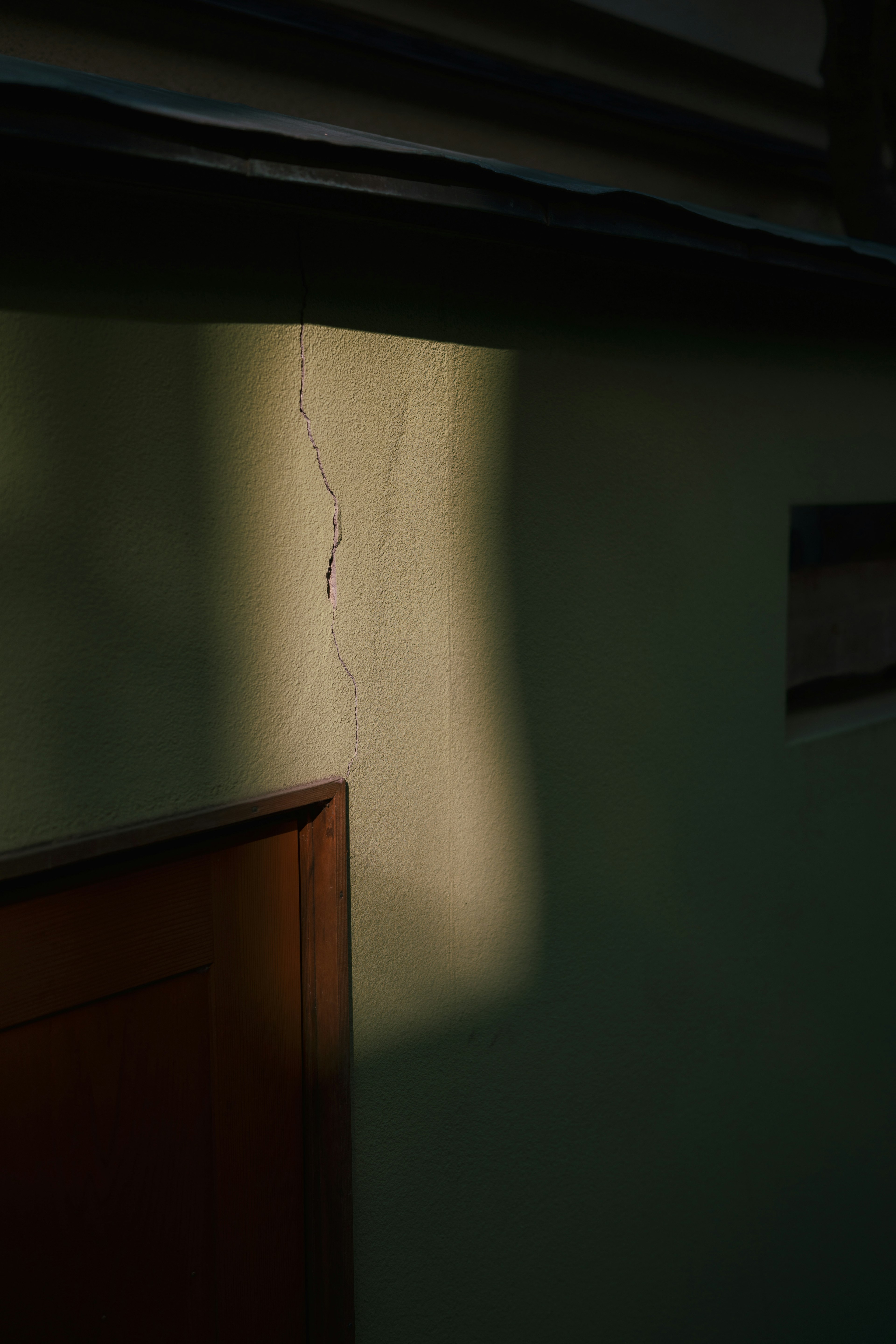 Soft light hitting a wall with a crack