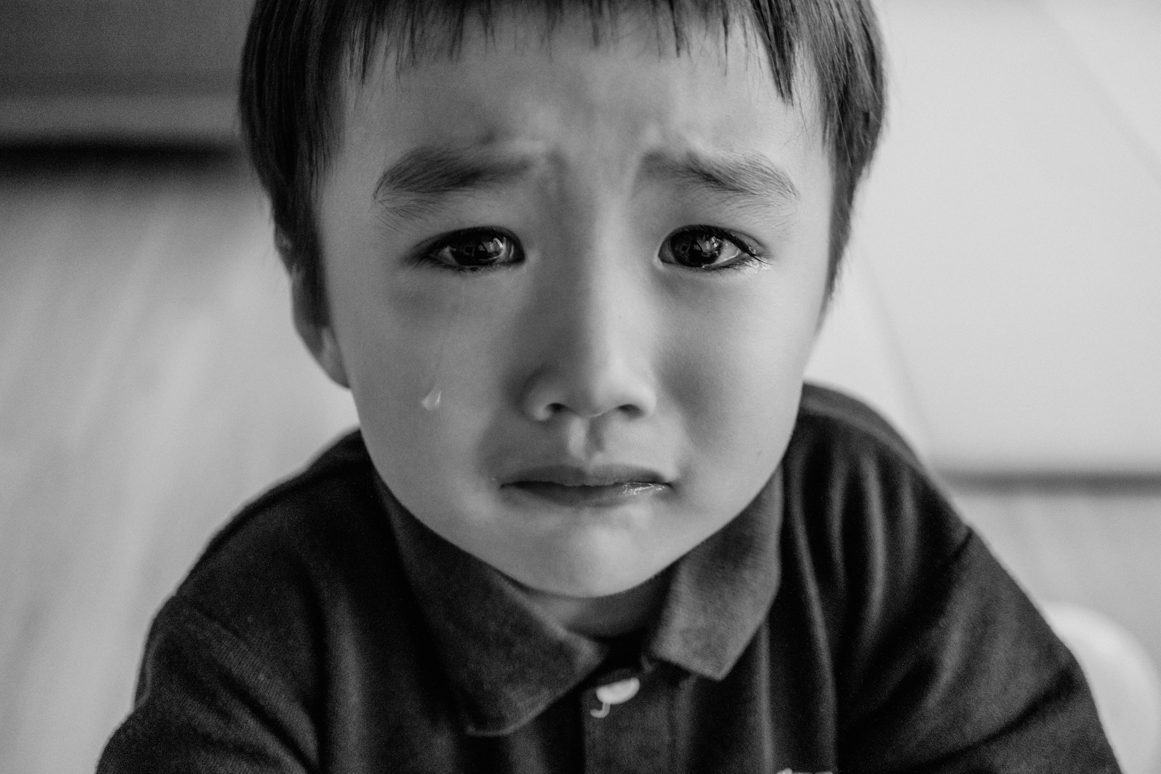 Child with a sad expression and tears