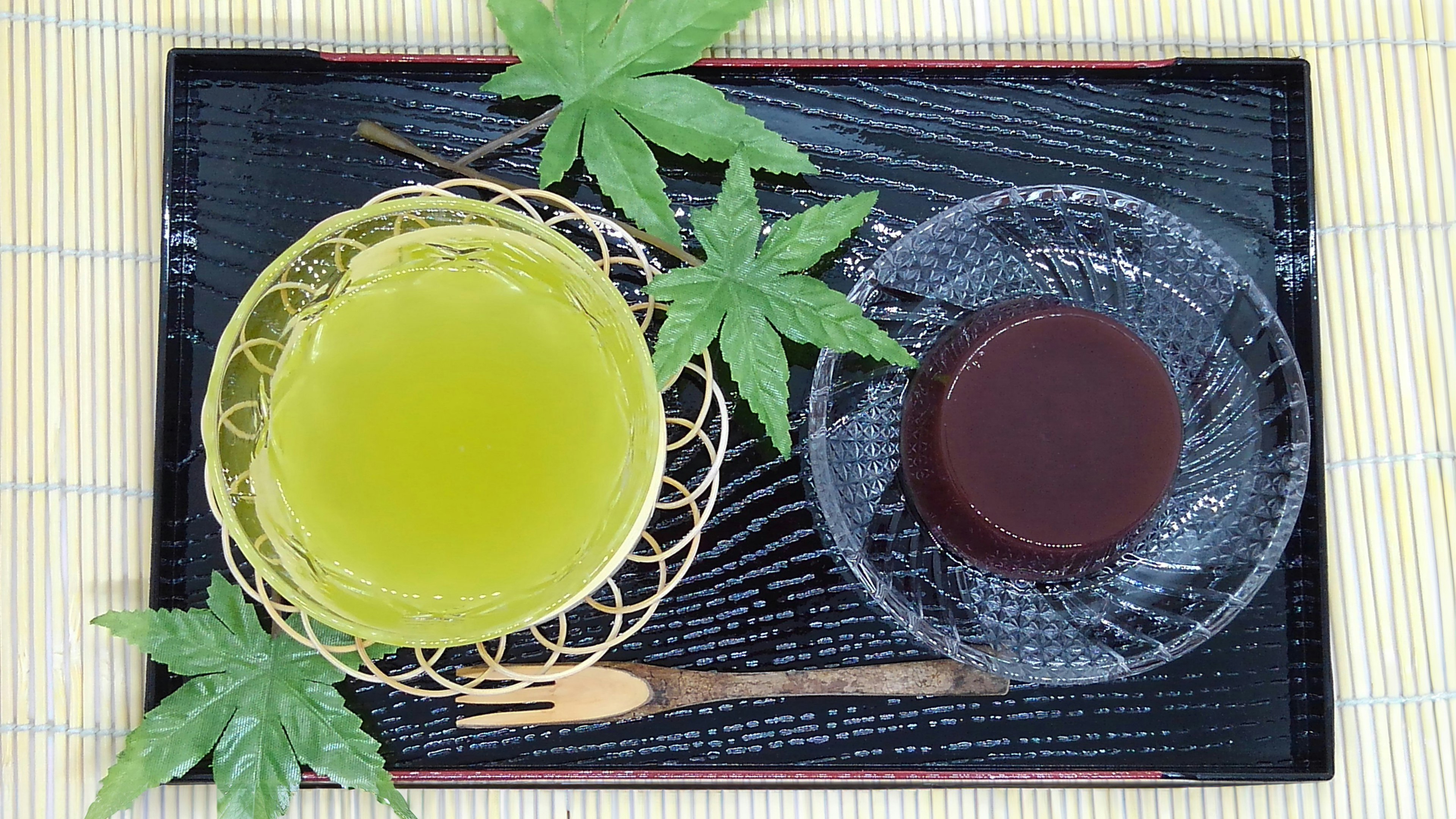 A traditional Japanese plate featuring green tea and sweet red bean jelly