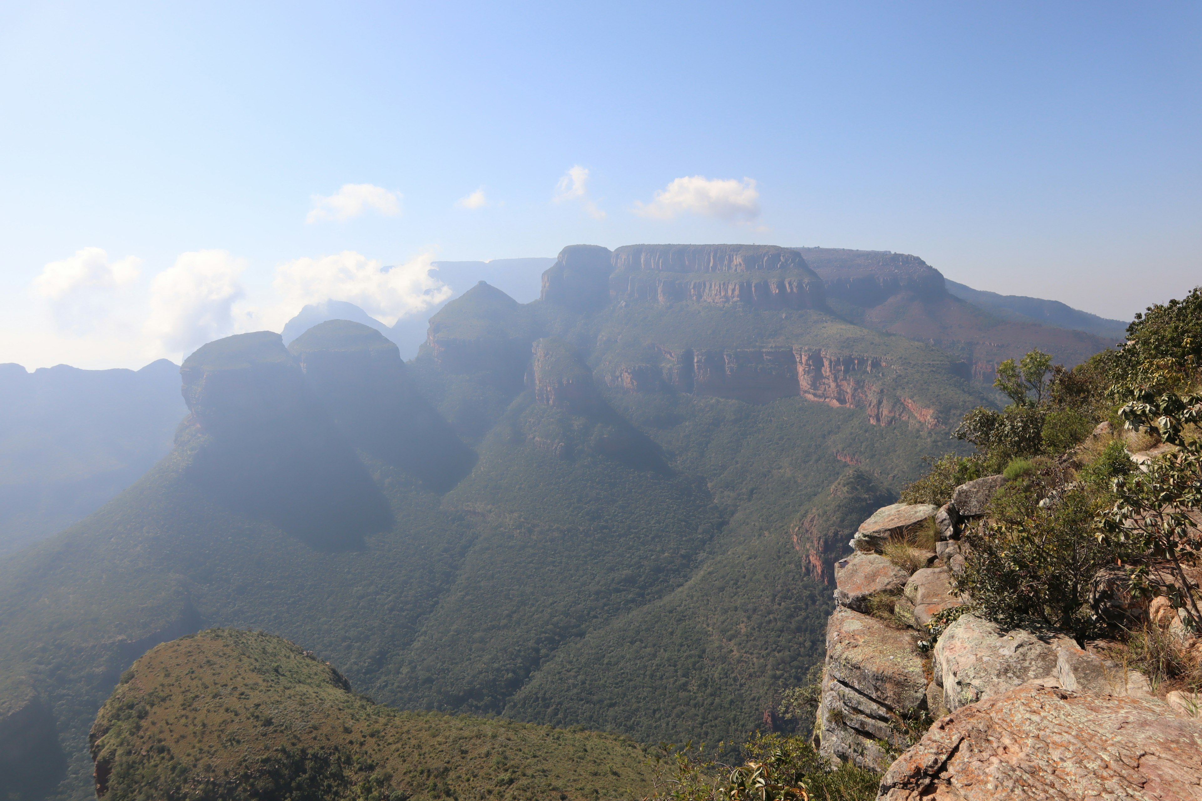 Panoramic view of lush green mountains with misty landscape