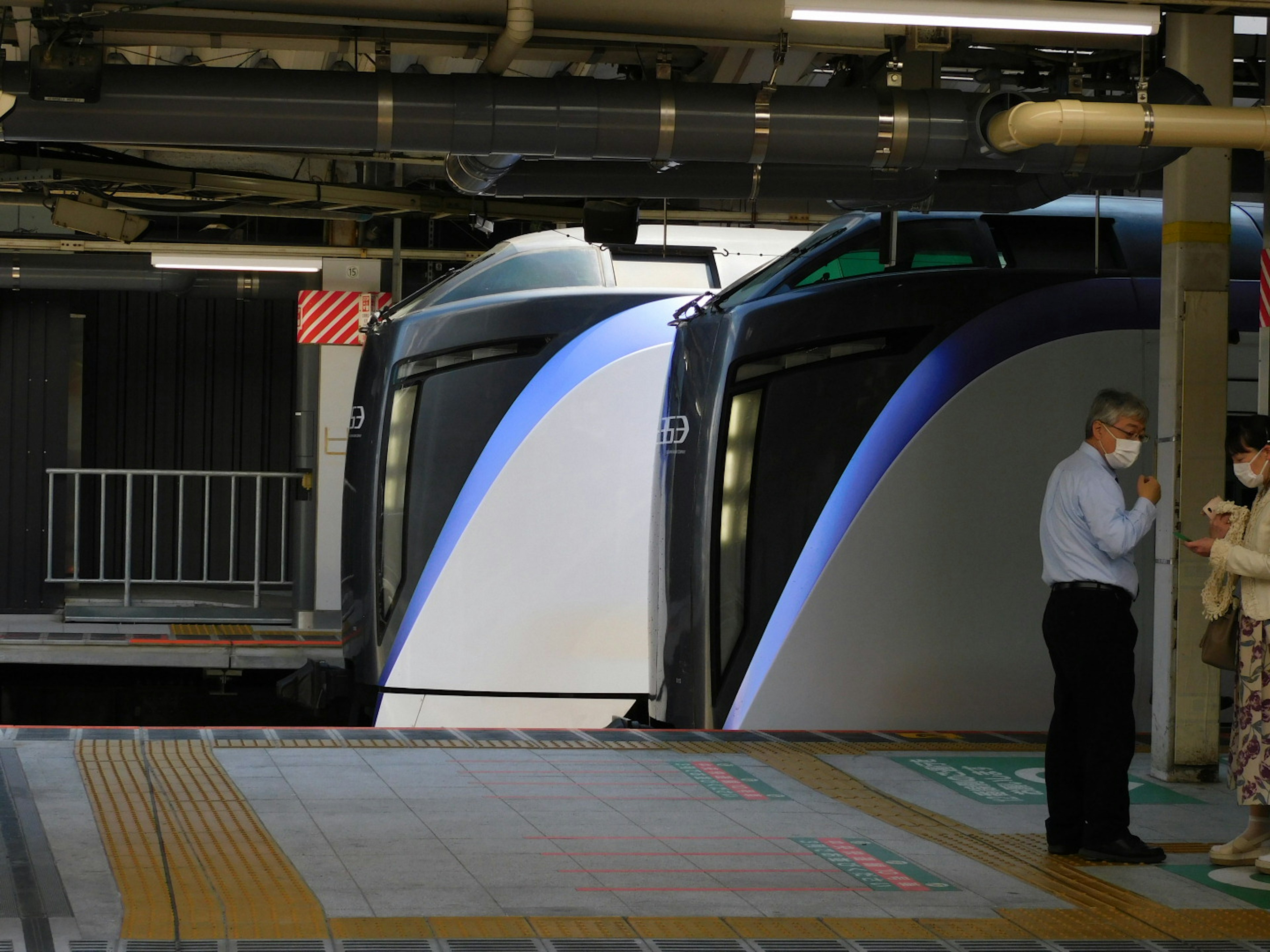 Passengers waiting at the station near the front of the train