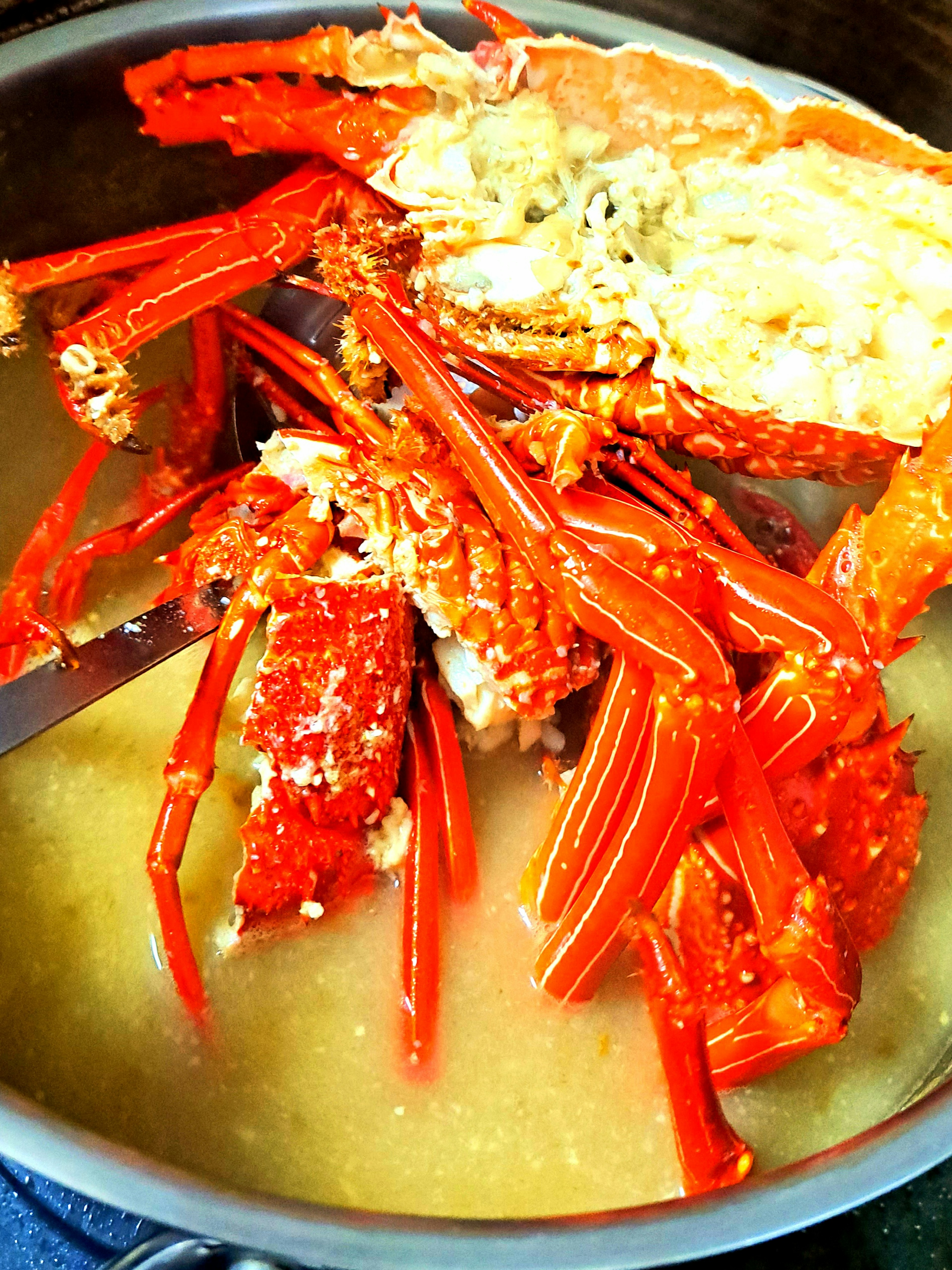 Vibrant red crab in a savory broth