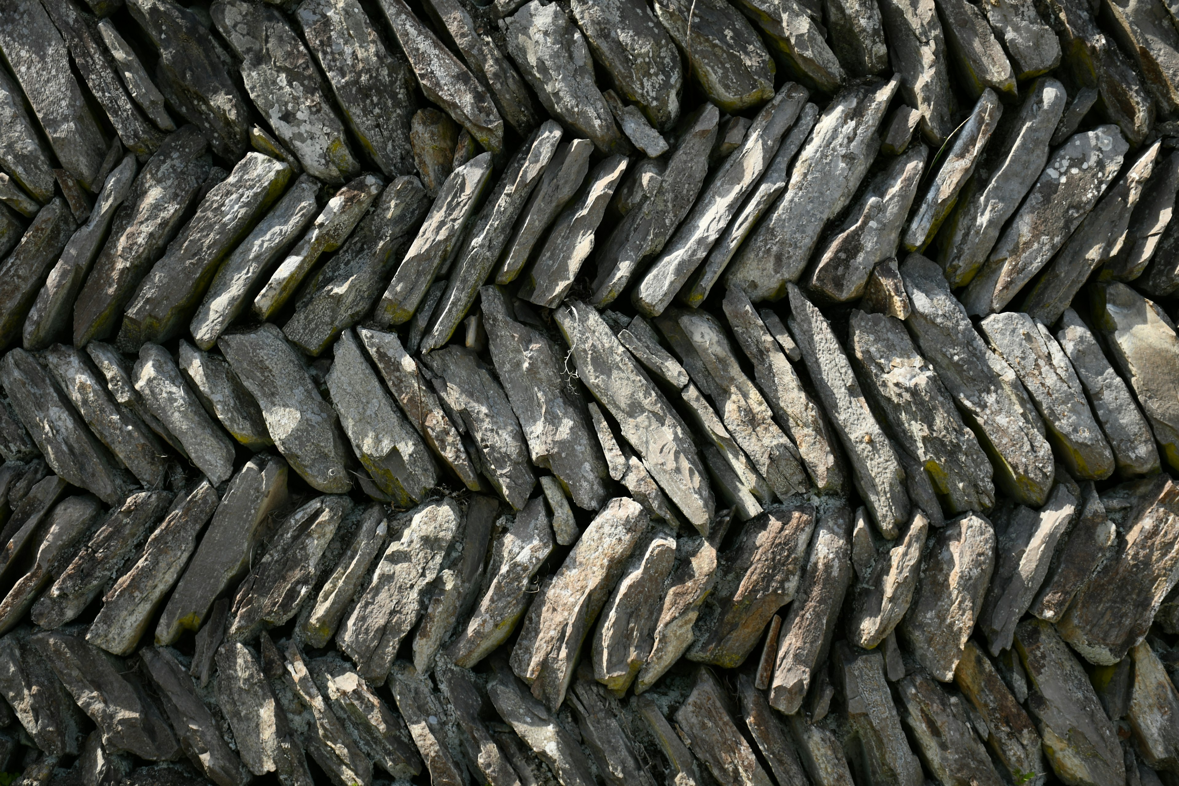 Textured pattern of interlocking stones arranged in a zigzag formation